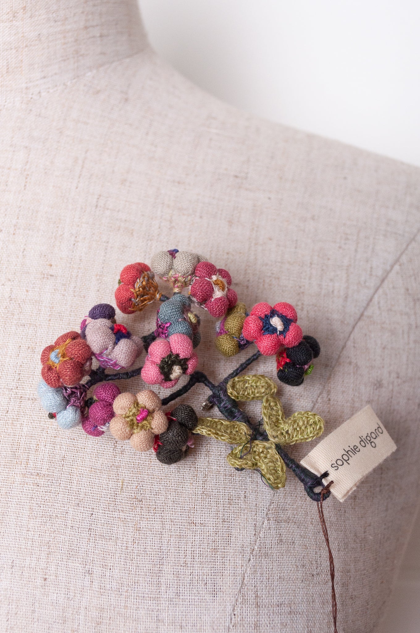 Sophie Digard colourful button flower brooch hand embroidered and crocheted in linen.