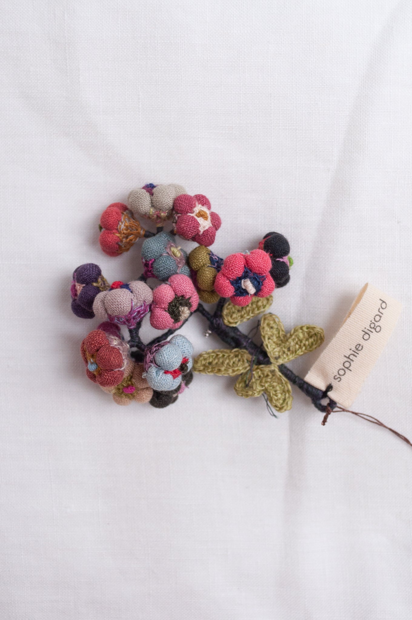 Sophie Digard colourful button flower brooch hand embroidered and crocheted in linen.