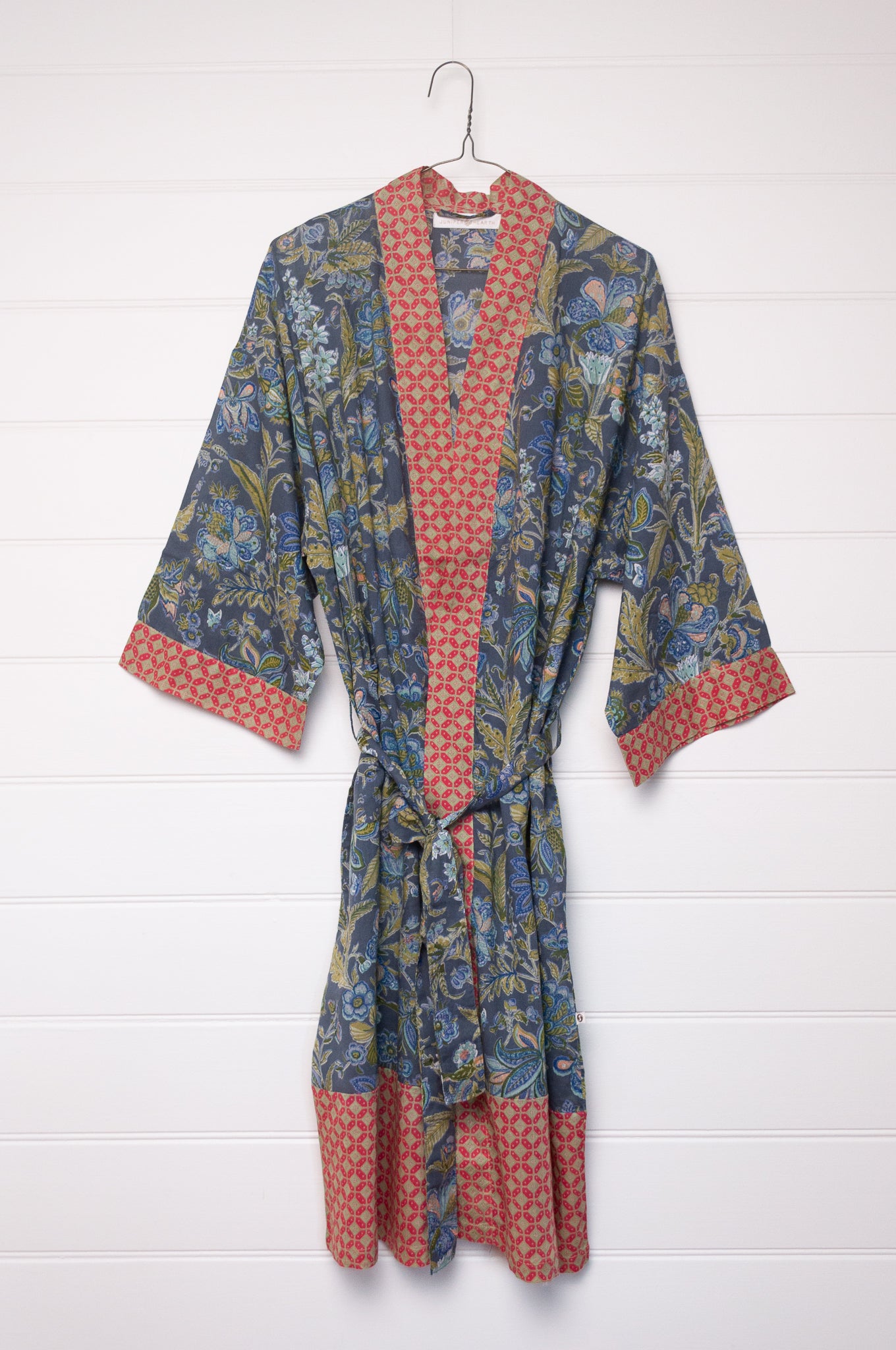 Juniper Hearth cotton voile kimono in tropical storm print, blue and olive green flowers on grey blue background.