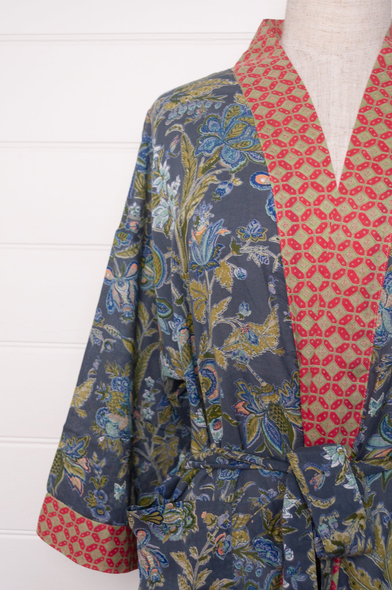 Juniper Hearth cotton voile kimono in tropical storm print, blue and olive green flowers on grey blue background.
