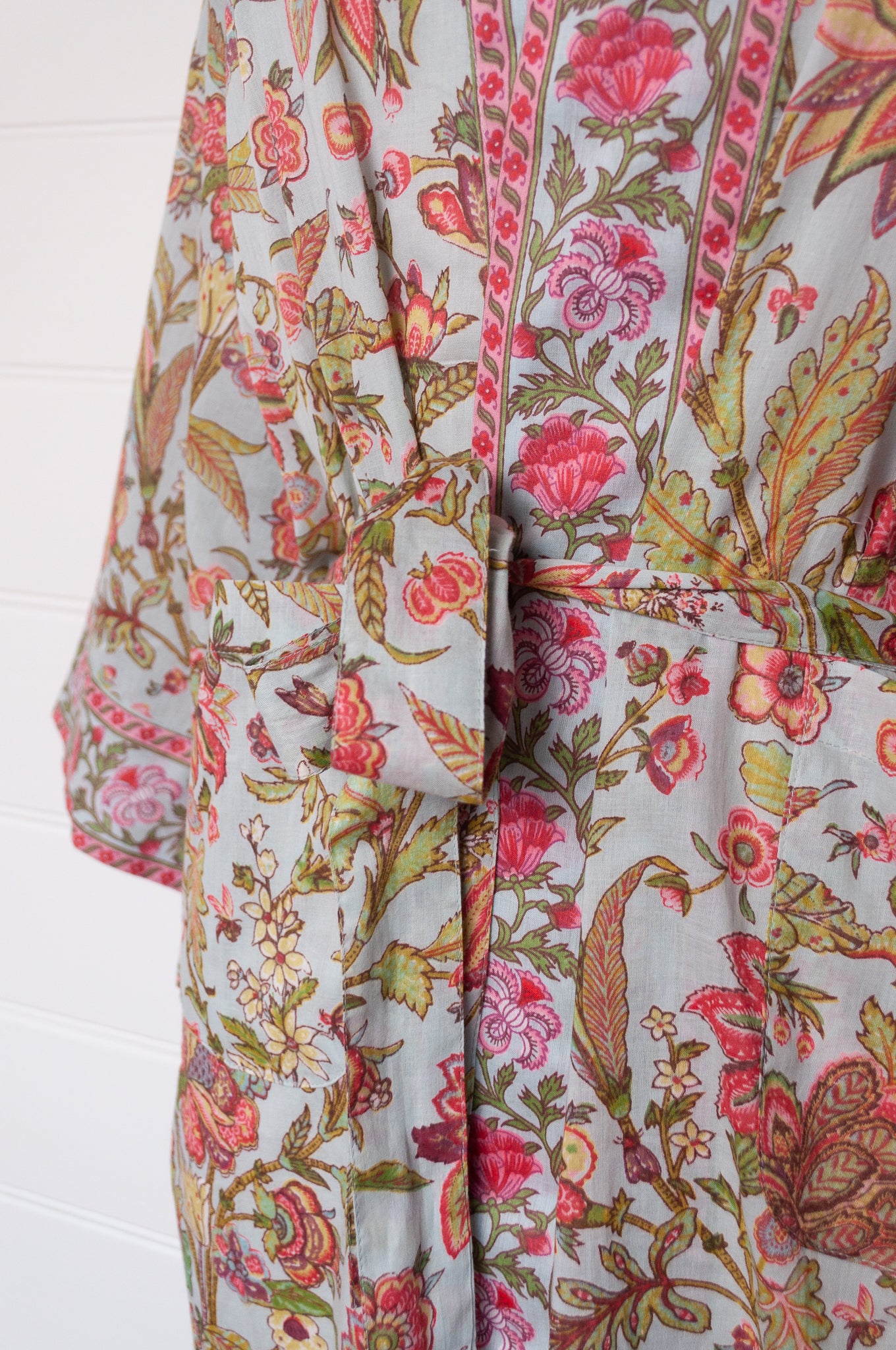 Juniper Hearth cotton voile kimono in tropical sky print, pink and lime green flowers on celadon blue background.