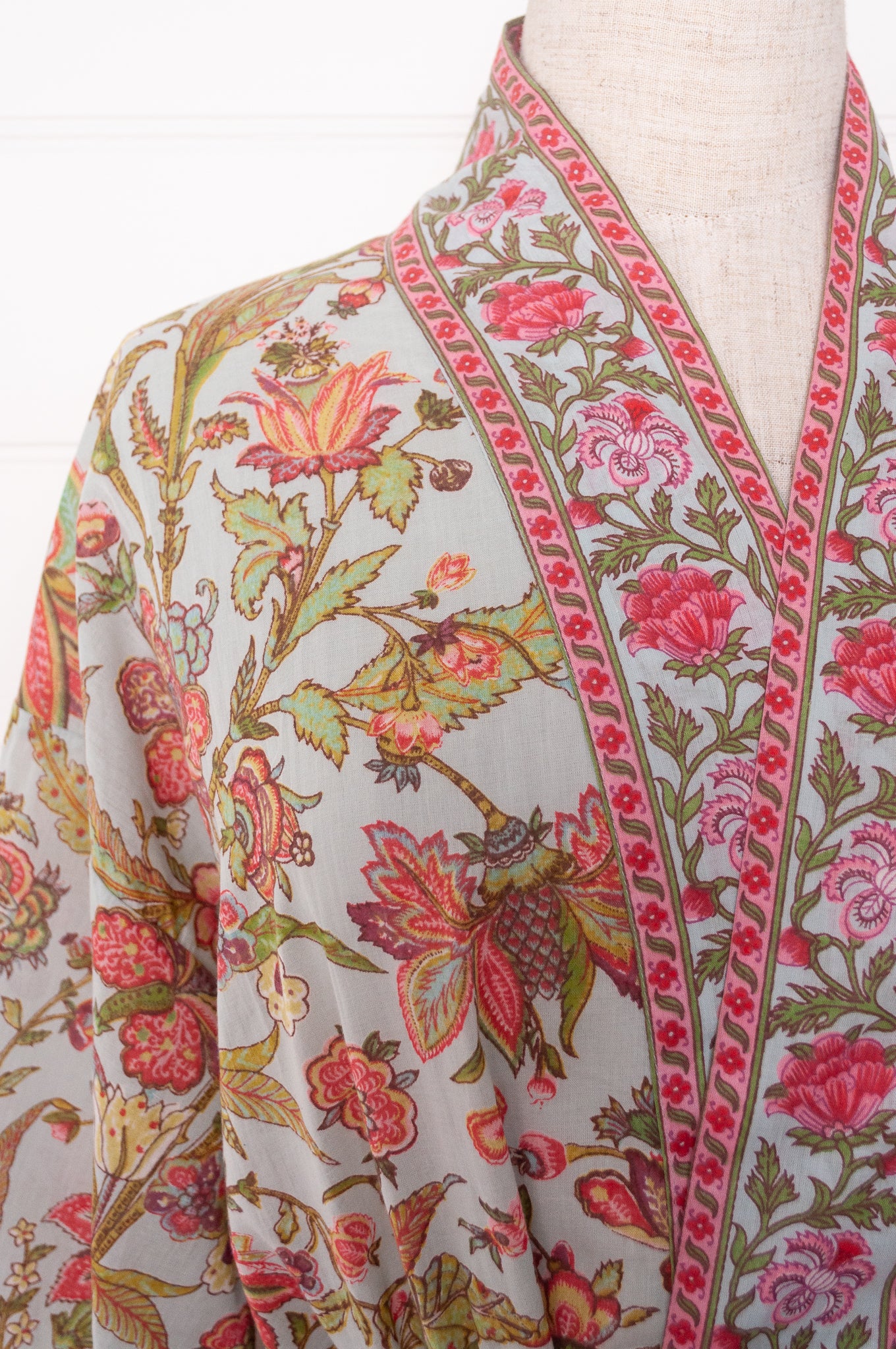Juniper Hearth cotton voile kimono in tropical sky print, pink and lime green flowers on celadon blue background.