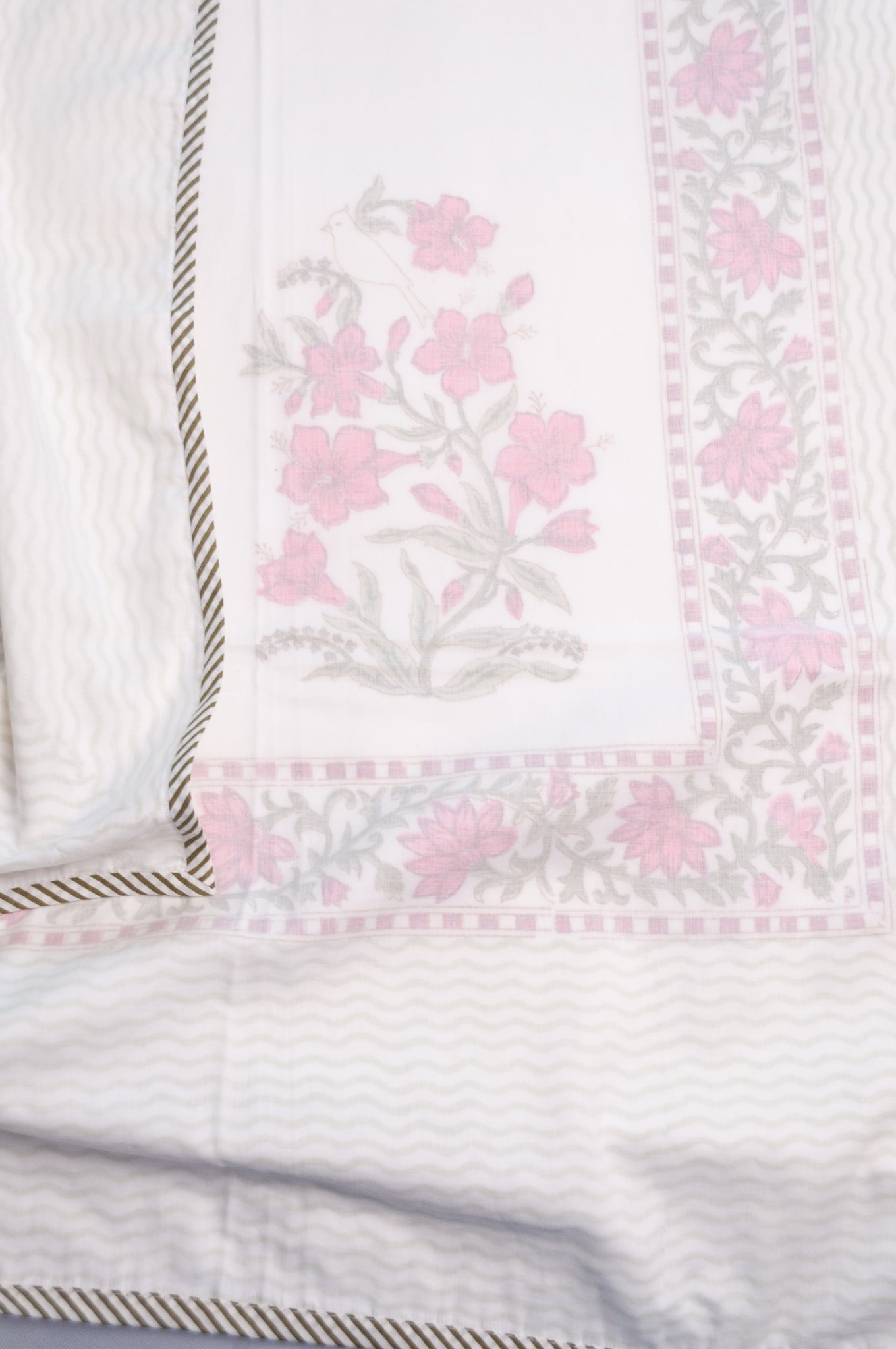 Single size cotton muslin blockprinted dohar, moghul design with pink flowers and cypress trees.