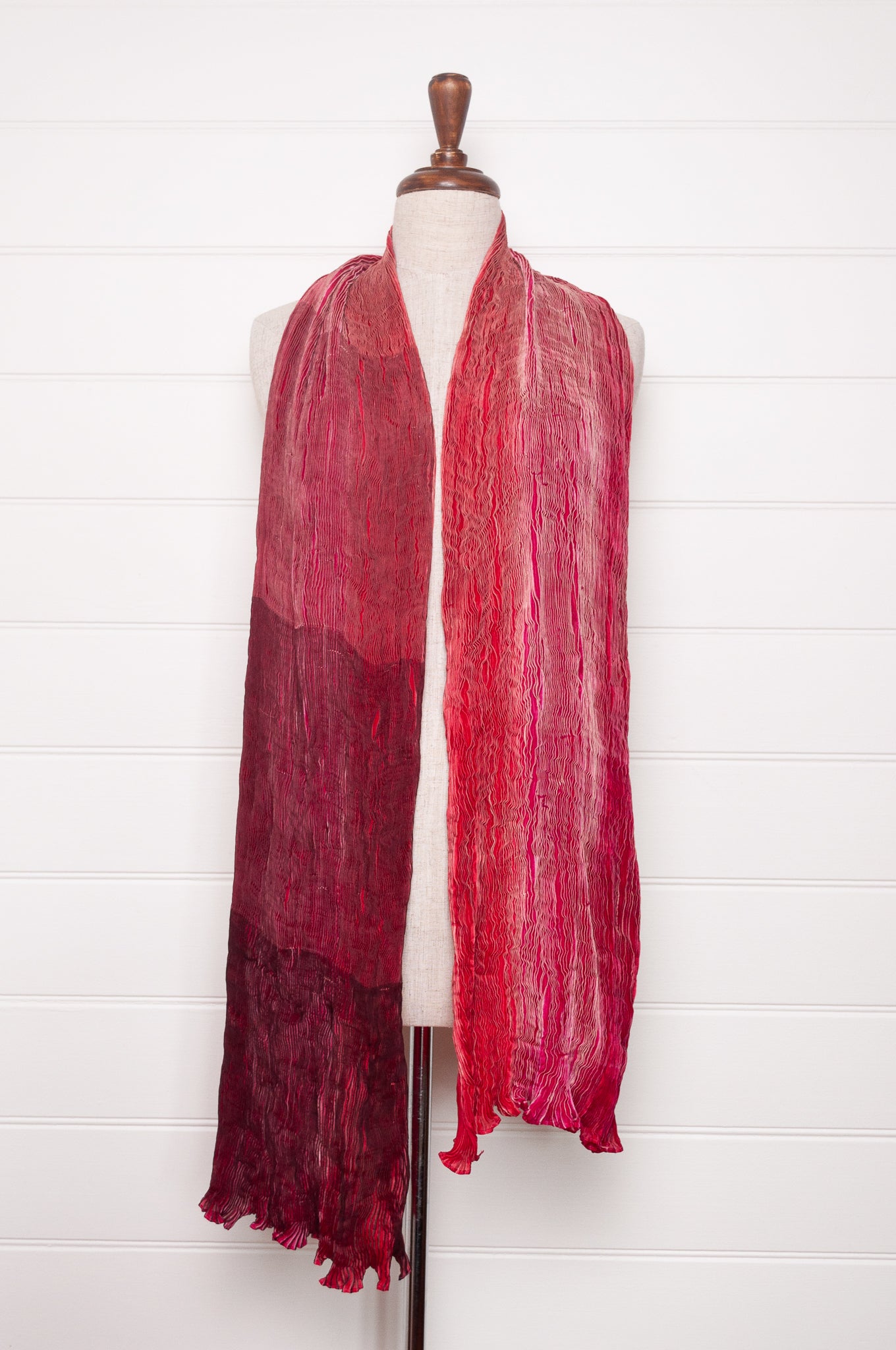 Crinkle shibori silk scarf in tones of magenta pink.