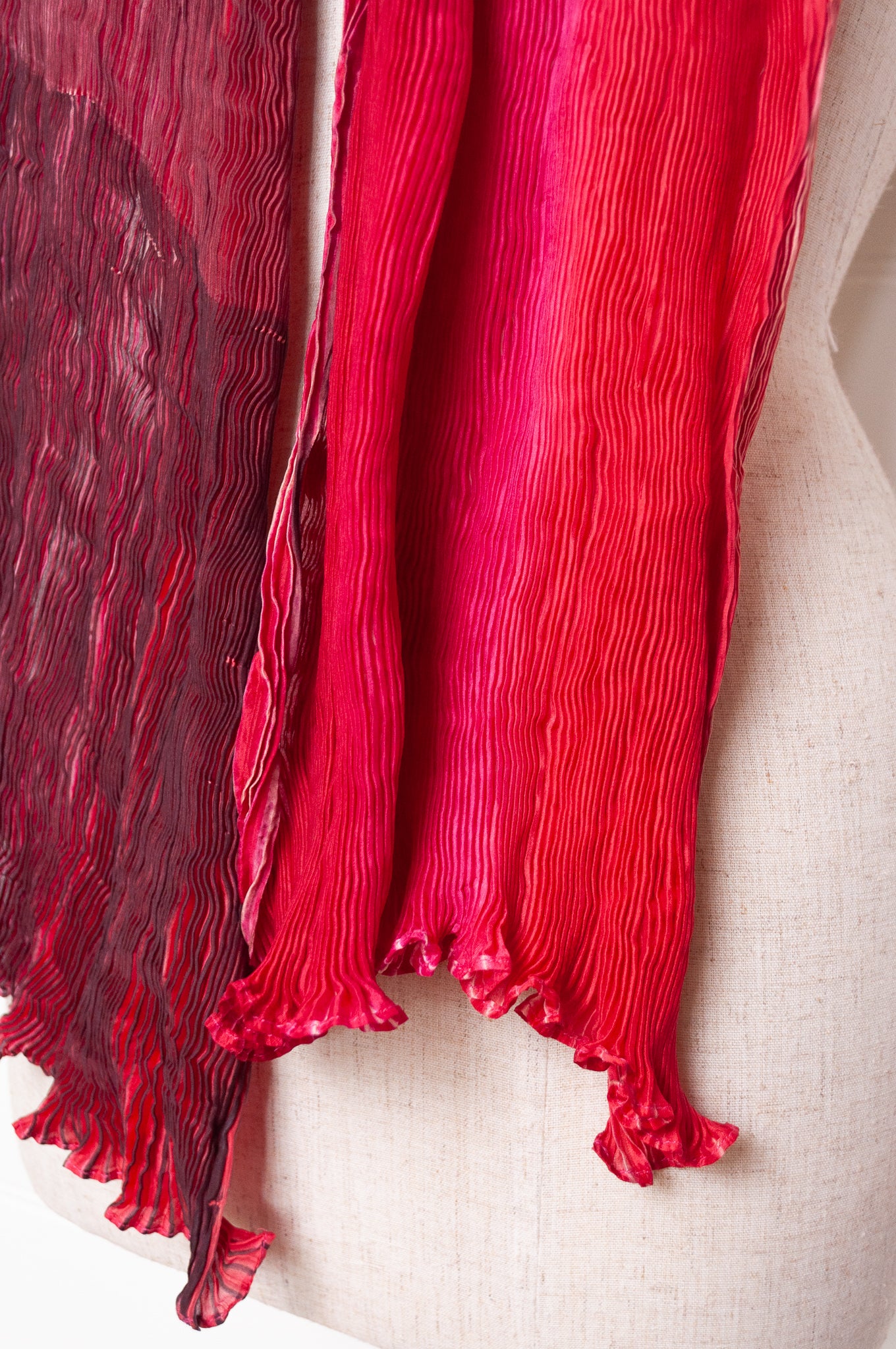 Crinkle shibori silk scarf in tones of magenta pink.