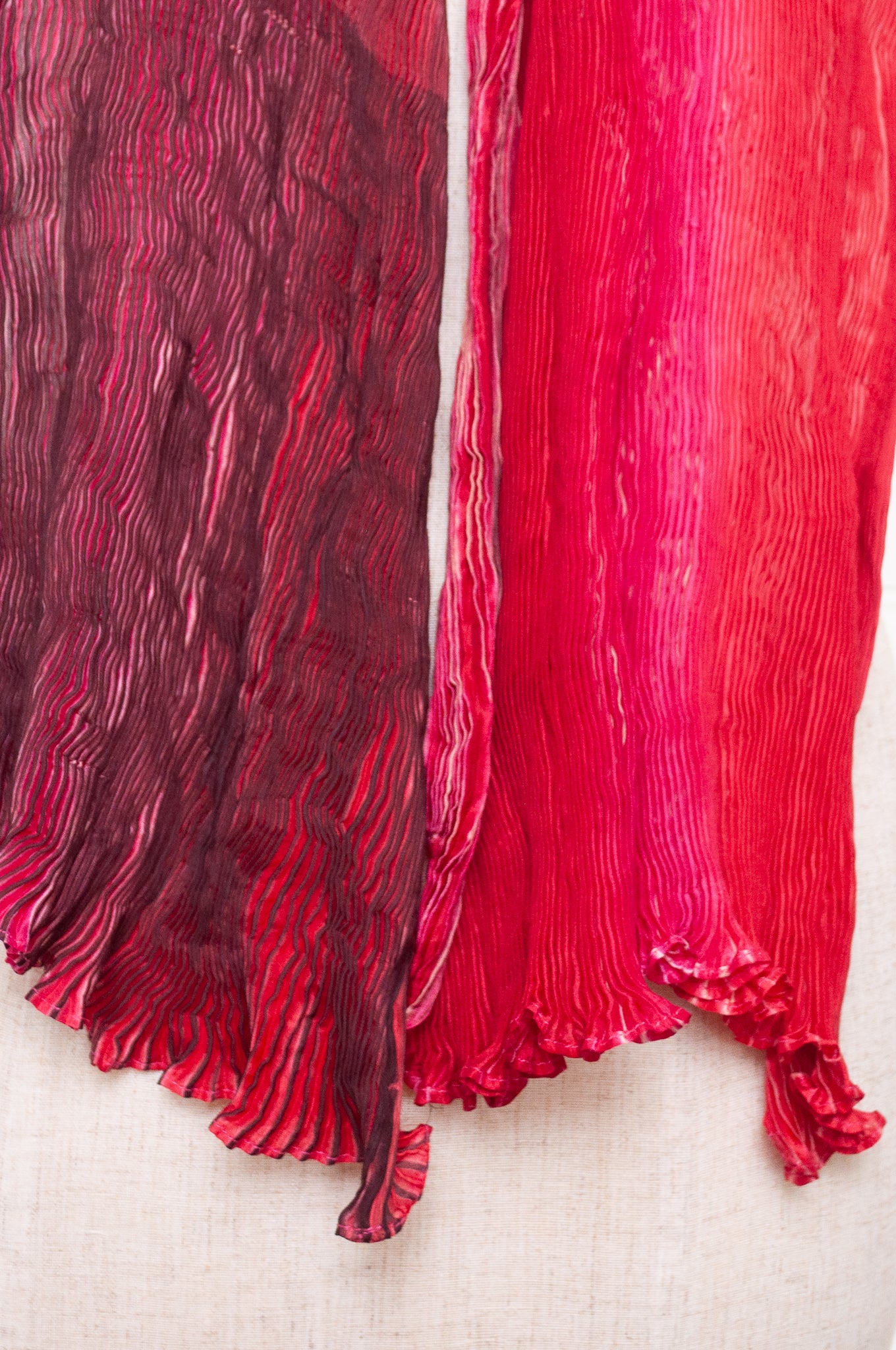 Crinkle shibori silk scarf in tones of magenta pink.