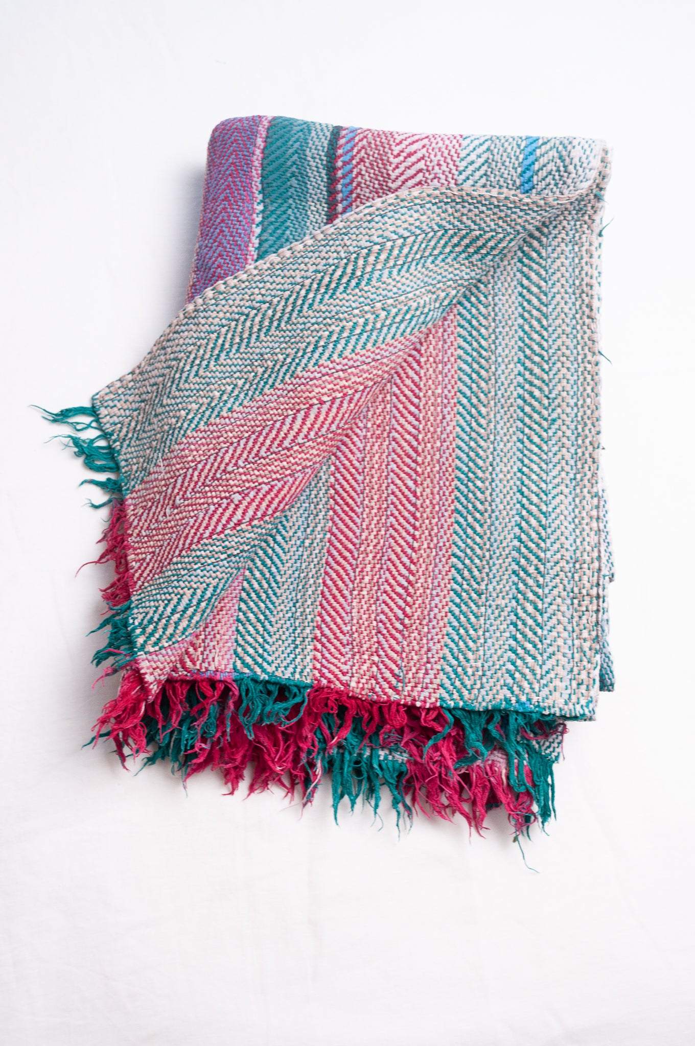 Vintage lohori stitch kantha quilt on multicoloured stripes.