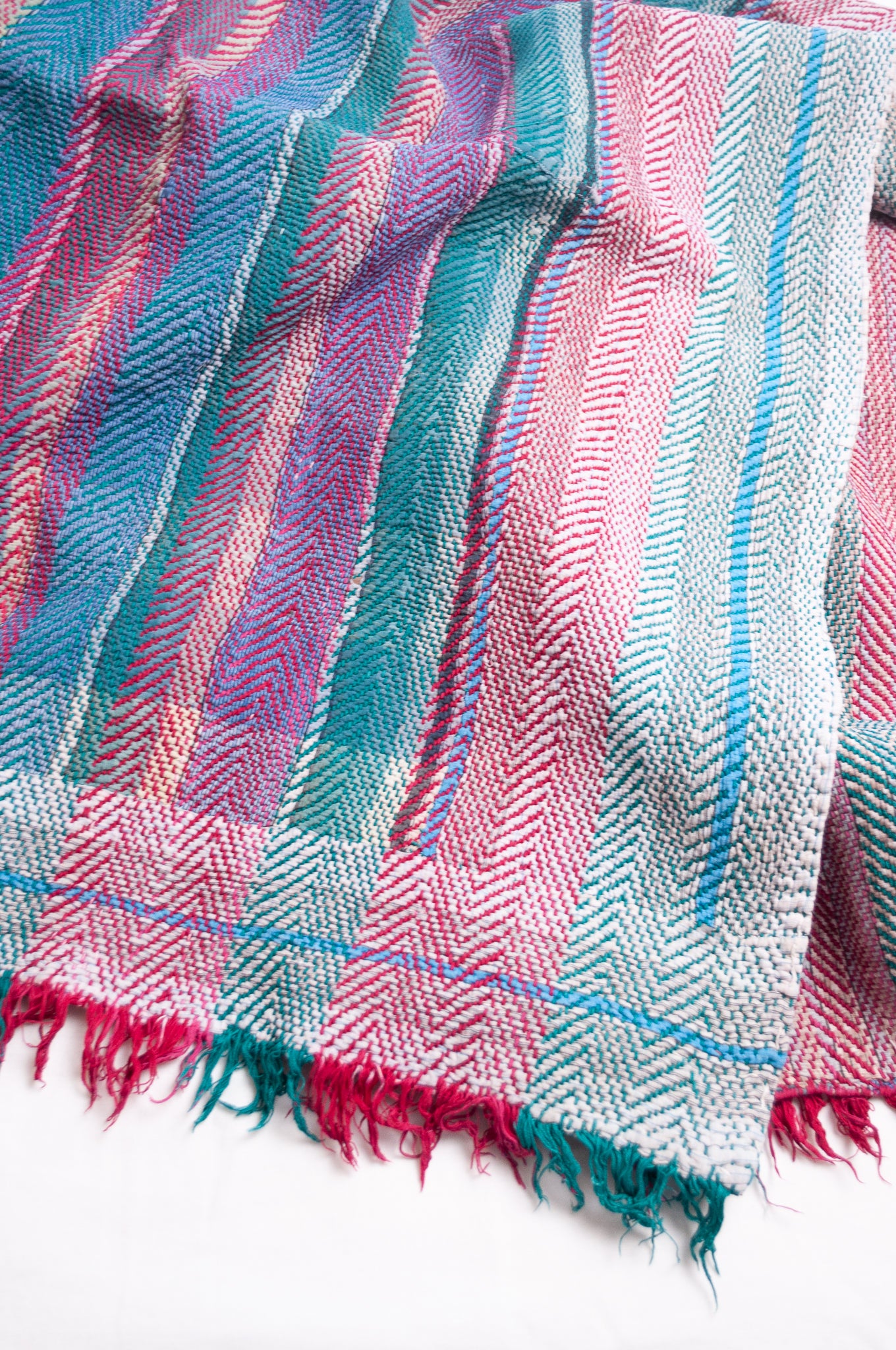 Vintage lohori stitch kantha quilt on multicoloured stripes.