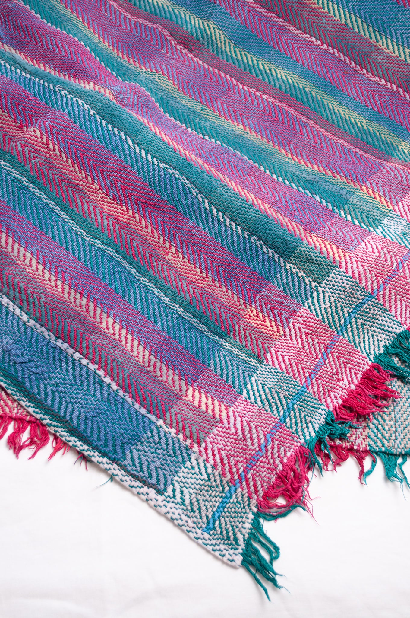 Vintage lohori stitch kantha quilt on multicoloured stripes.