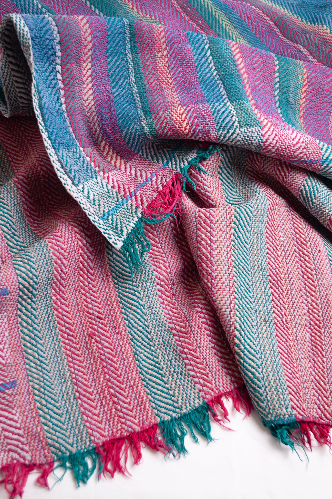 Vintage lohori stitch kantha quilt on multicoloured stripes.
