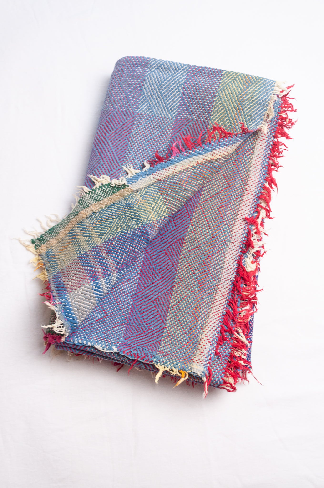 Vintage lohori stitch kantha quilt on multicoloured base.