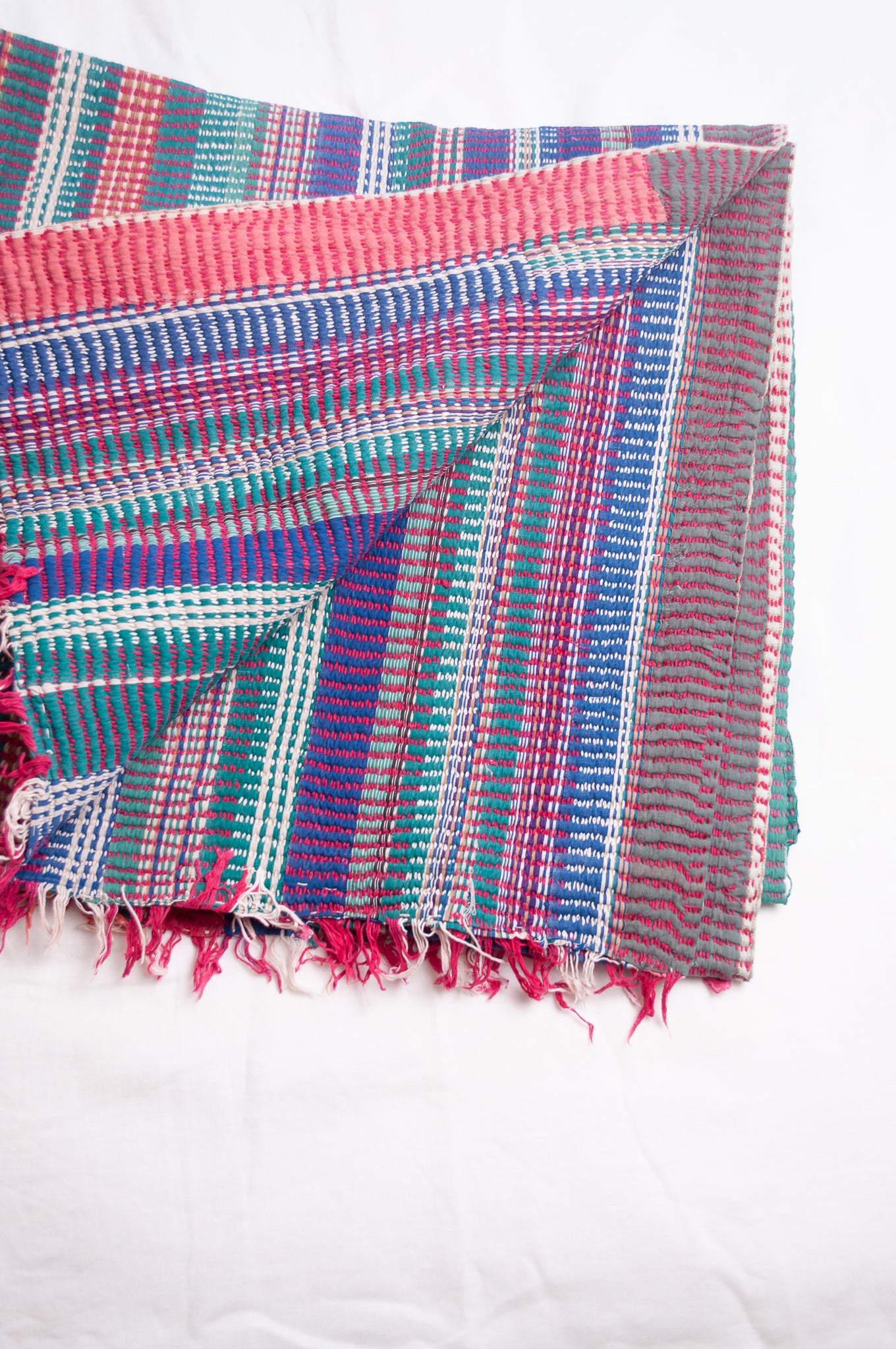 Vintage lohori stitch kantha quilt on multicoloured stripes.