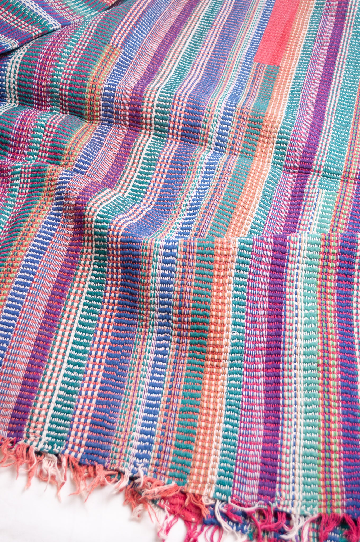 Vintage lohori stitch kantha quilt on multicoloured stripes.