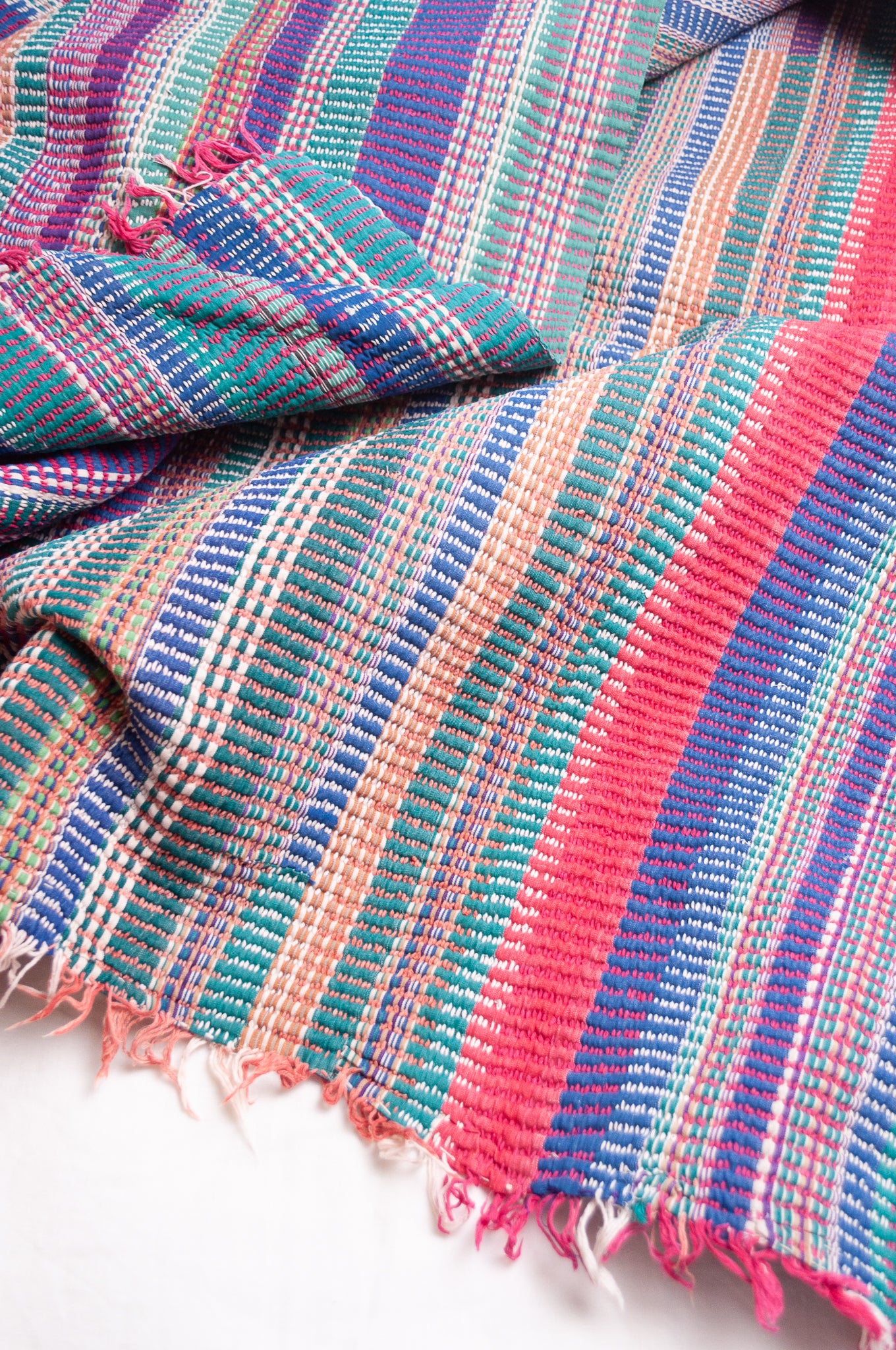 Vintage lohori stitch kantha quilt on multicoloured stripes.