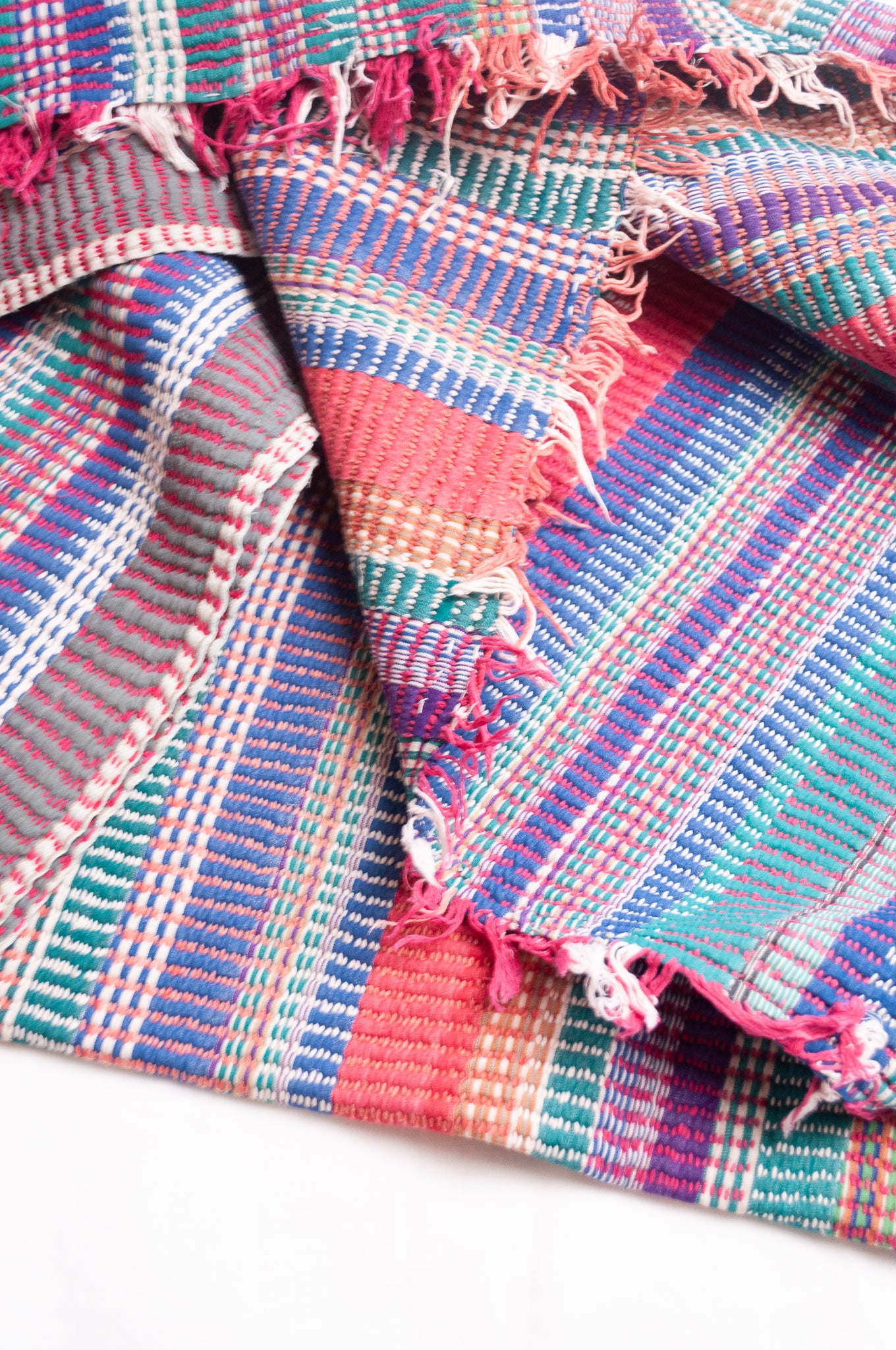 Vintage lohori stitch kantha quilt on multicoloured stripes.