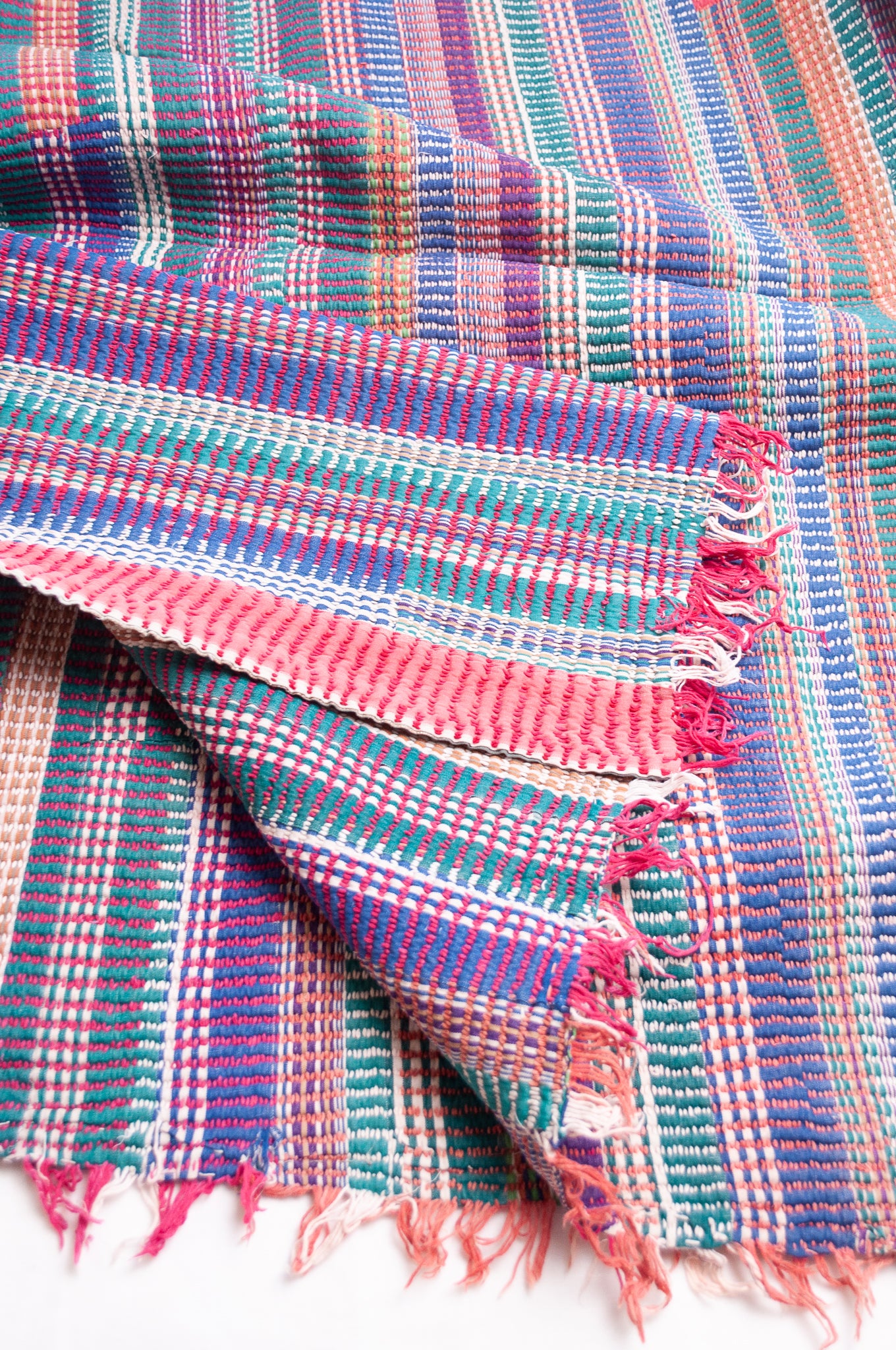 Vintage lohori stitch kantha quilt on multicoloured stripes.