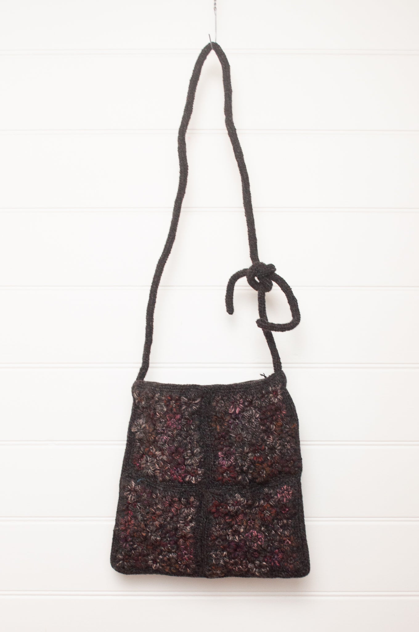 Sophie Digard cross body crocheted freesia flower wool bag in graphite with pink tweed flowers.
