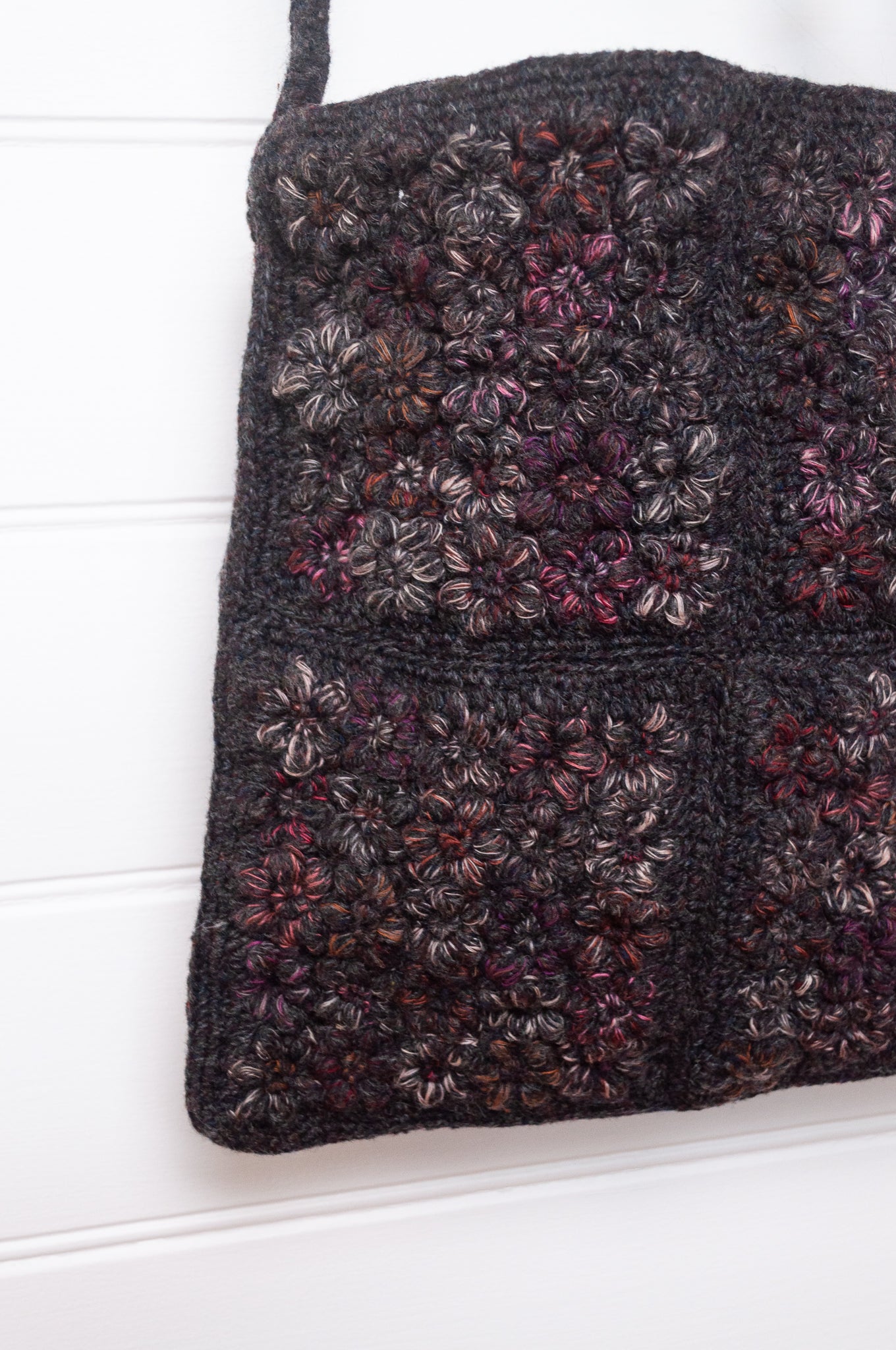 Sophie Digard cross body crocheted freesia flower wool bag in graphite with pink tweed flowers.