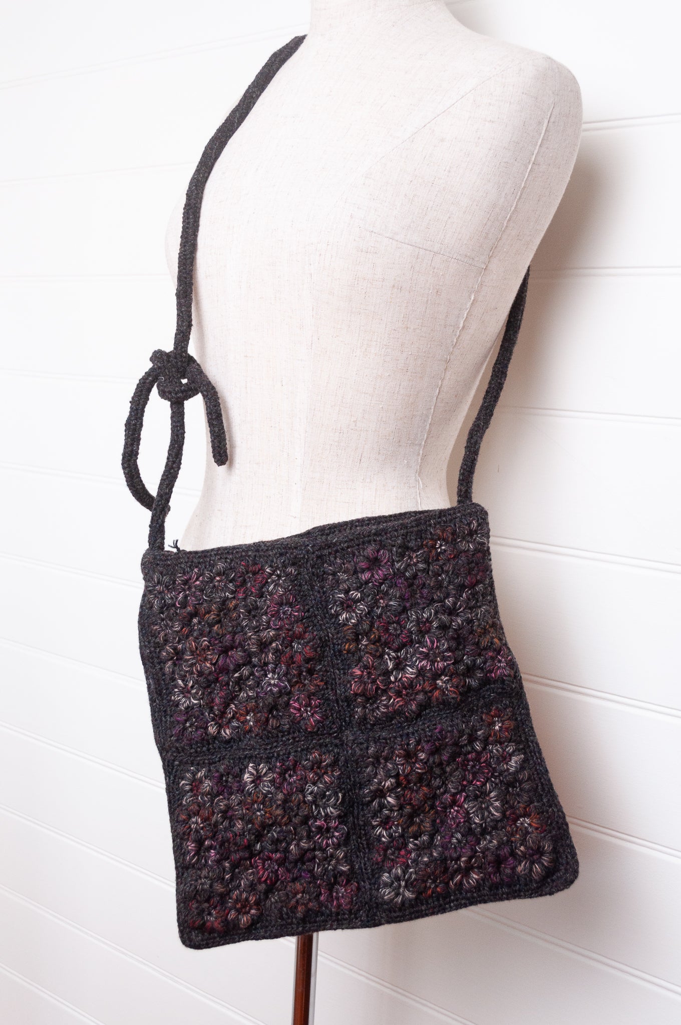 Sophie Digard cross body crocheted freesia flower wool bag in graphite with pink tweed flowers.
