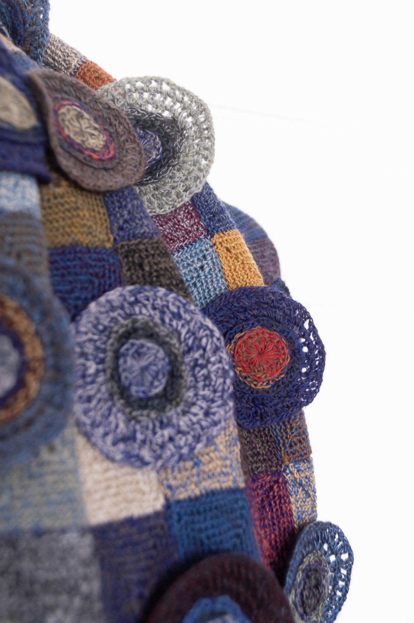 Sophie Digard crocheted wool scarf featuring patchwork with 3D rosettes in ink palette.