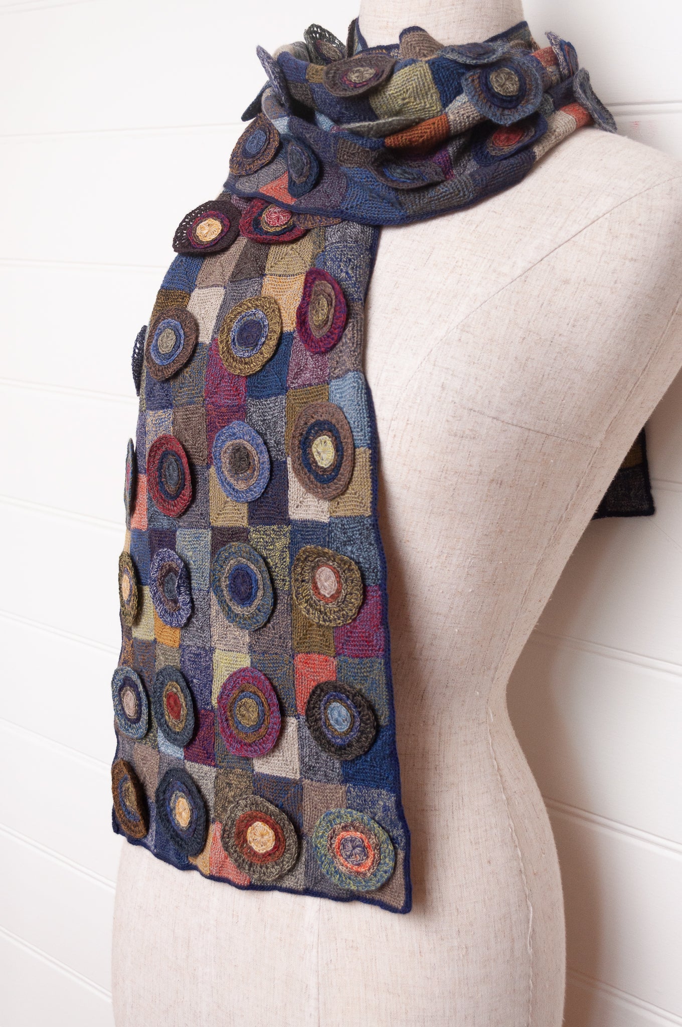 Sophie Digard crocheted wool scarf featuring patchwork with 3D rosettes in ink palette.