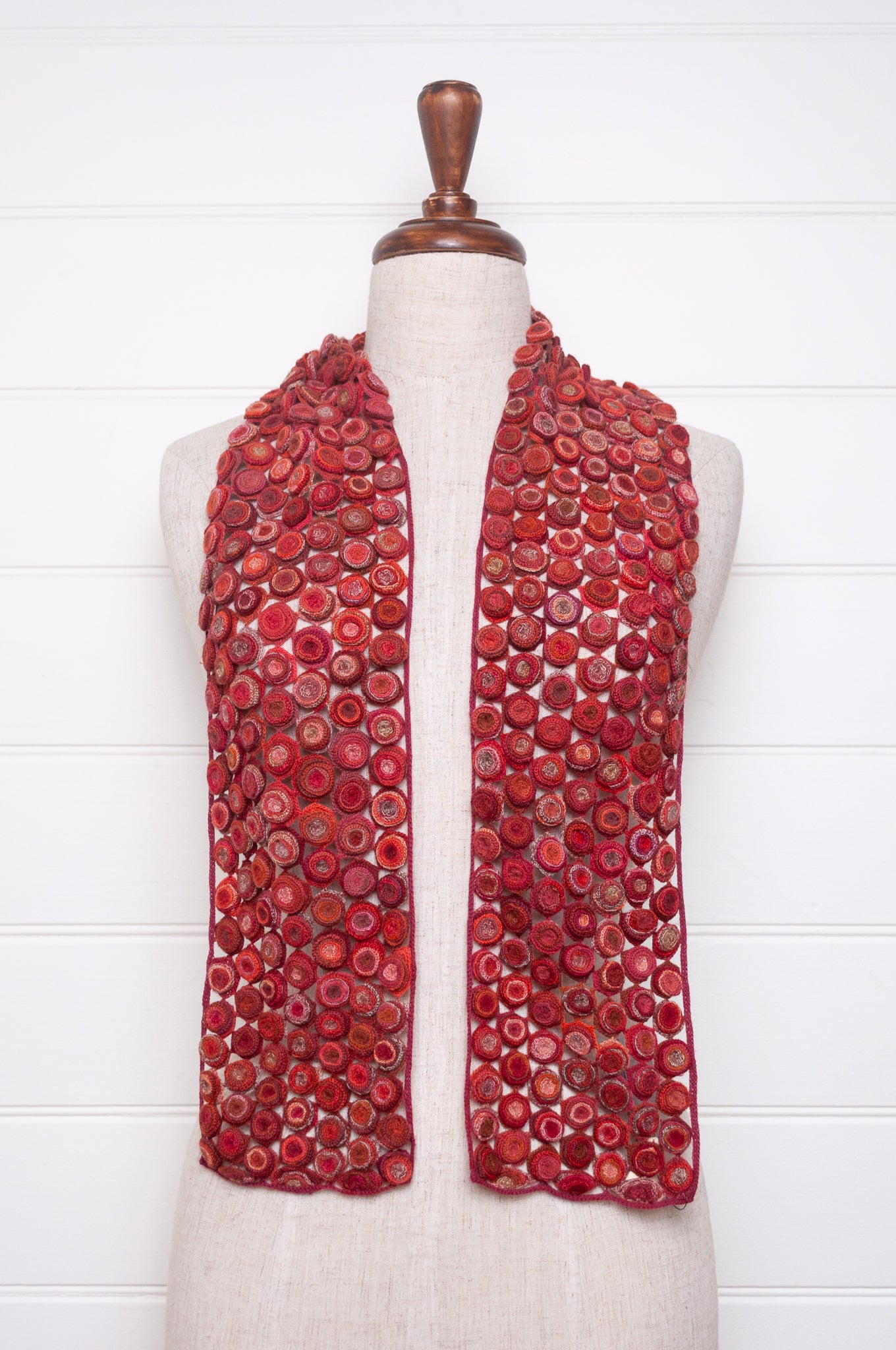 Sophie Digard crochet wool scarf with layered circle medallions in rich red, pink and rust palette.