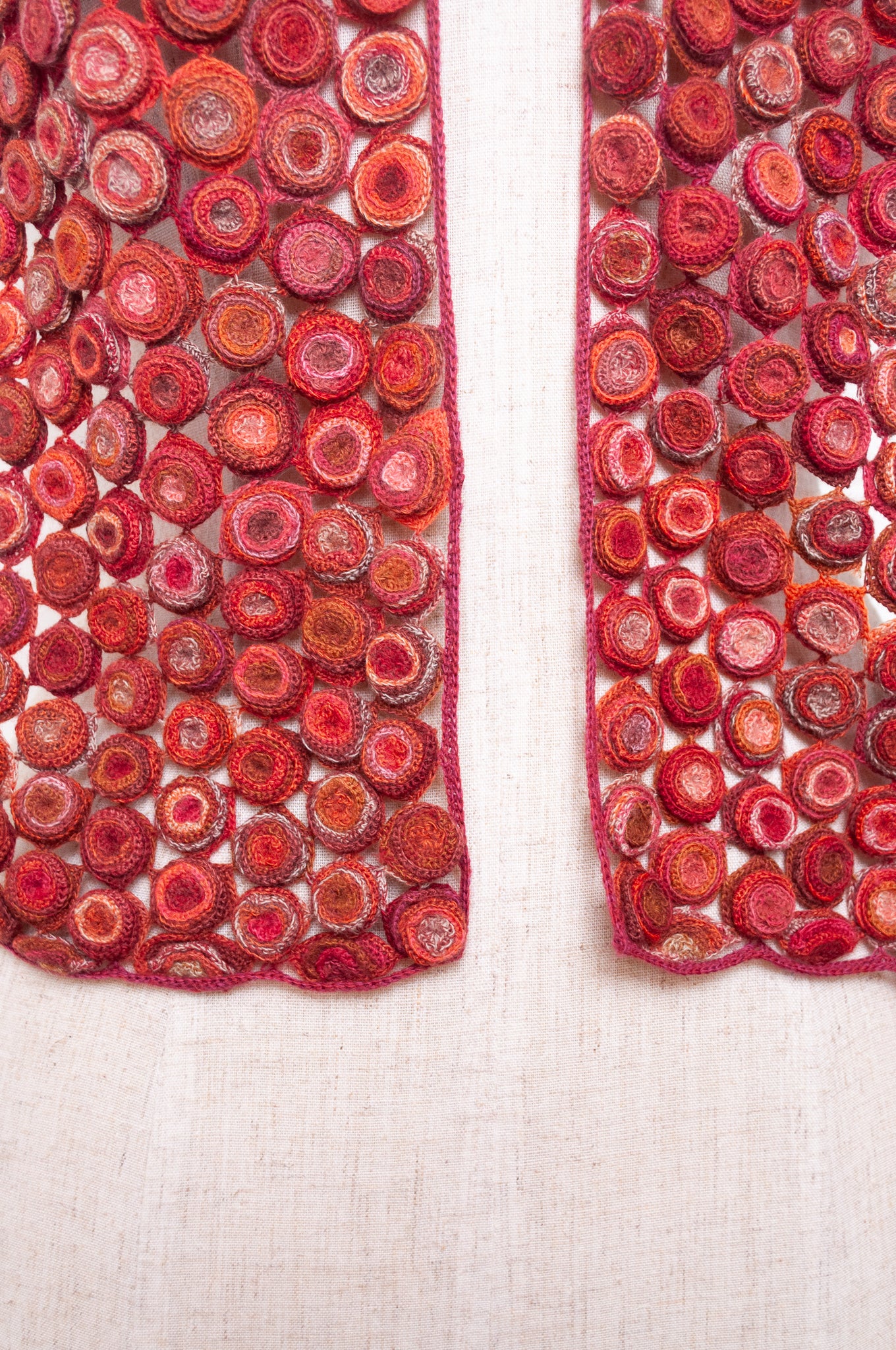 Sophie Digard crochet wool scarf with layered circle medallions in rich red, pink and rust palette.