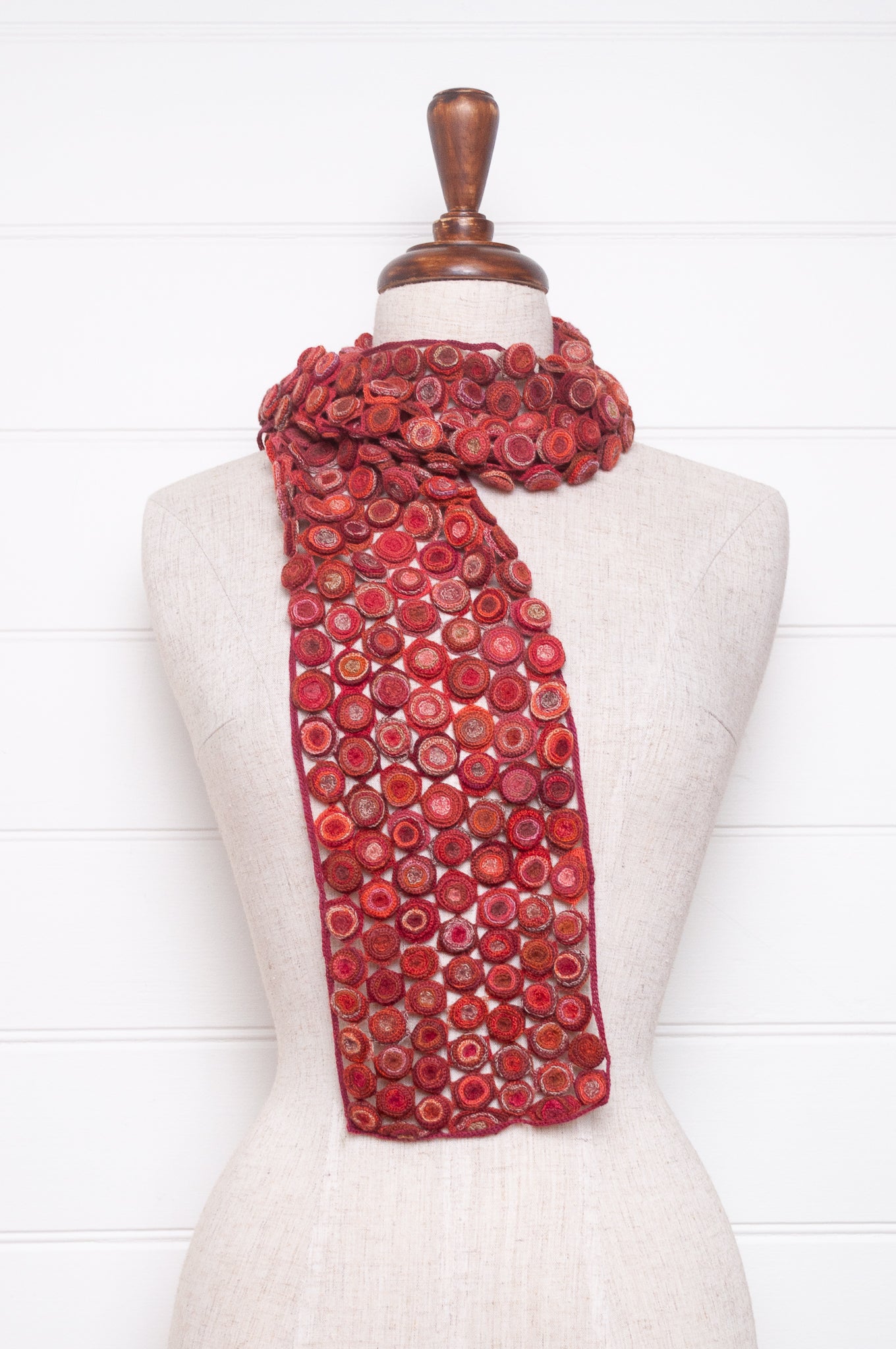 Sophie Digard crochet wool scarf with layered circle medallions in rich red, pink and rust palette.