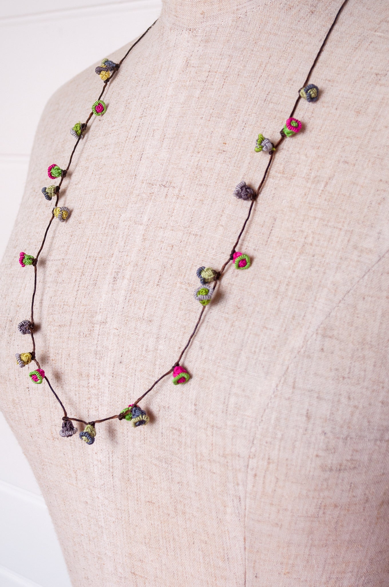 Handmade Moroccan button necklace in rose pink and sage greens.