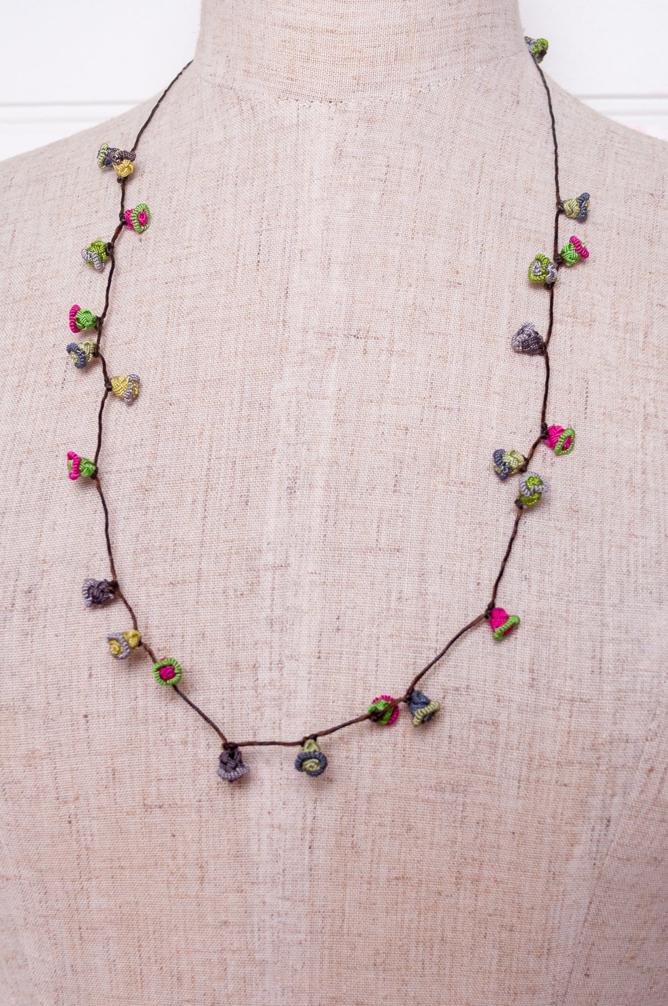 Handmade Moroccan button necklace in rose pink and sage greens.