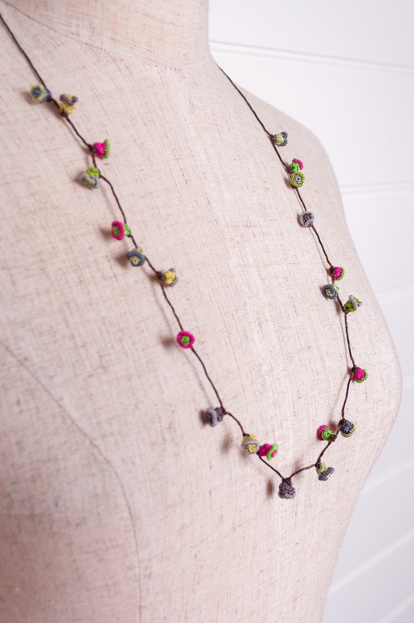 Handmade Moroccan button necklace in rose pink and sage greens.