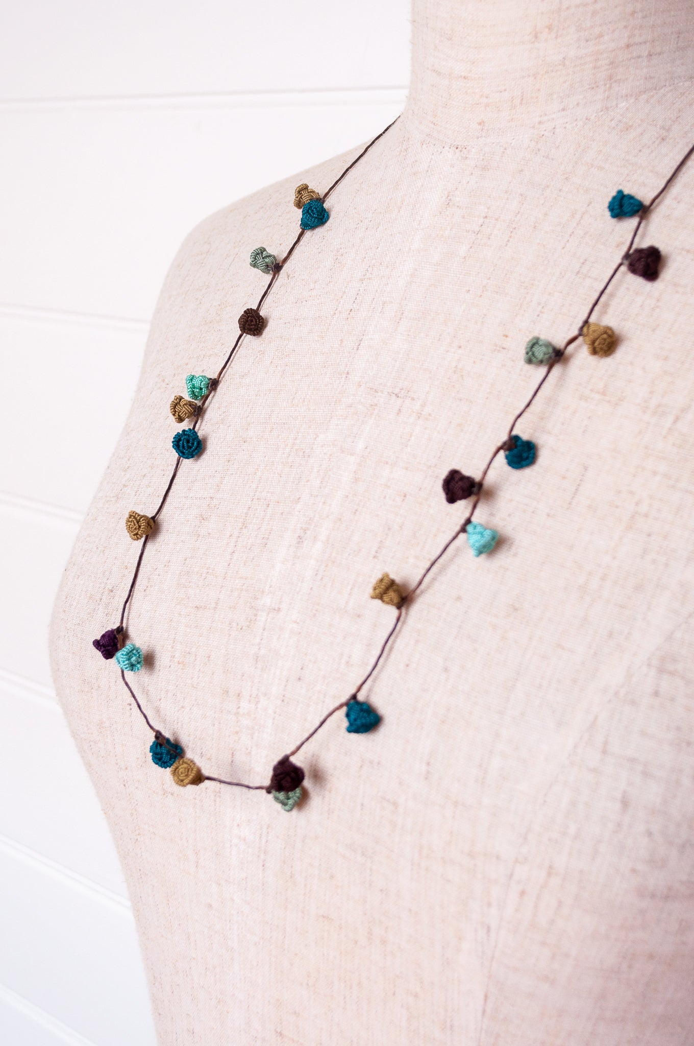 Handmade Moroccan button necklace in shades of green and brown.