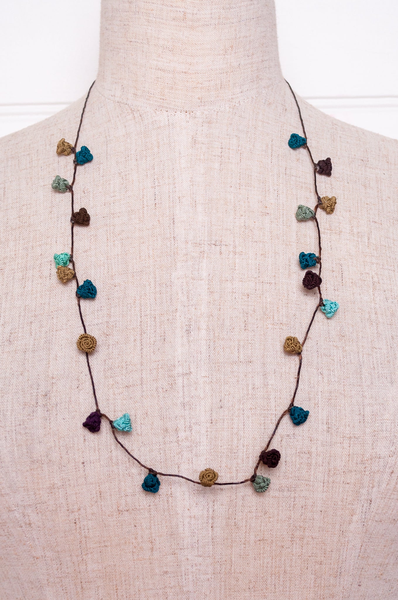 Handmade Moroccan button necklace in shades of green and brown.