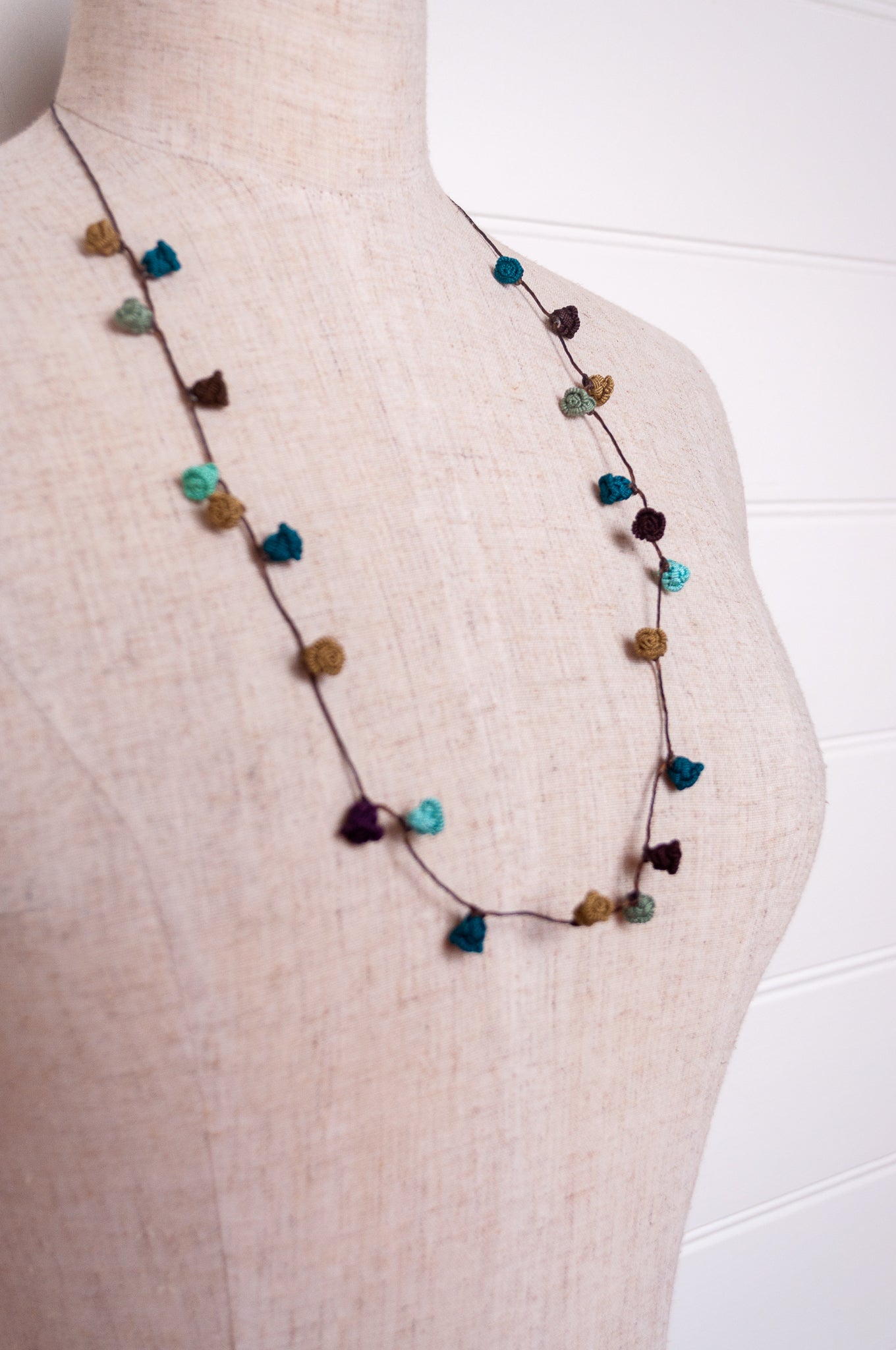 Handmade Moroccan button necklace in shades of green and brown.