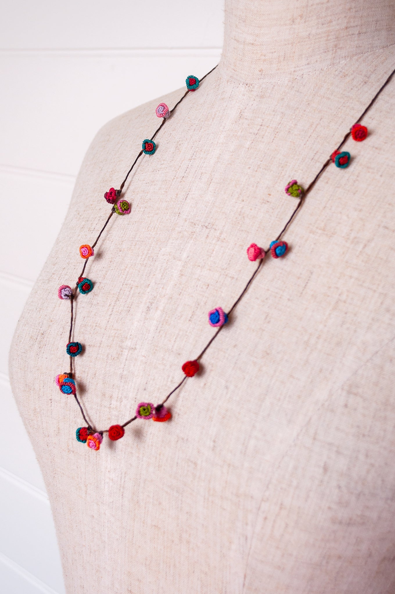 Handmade Moroccan button necklace in turquoise, pink and red.