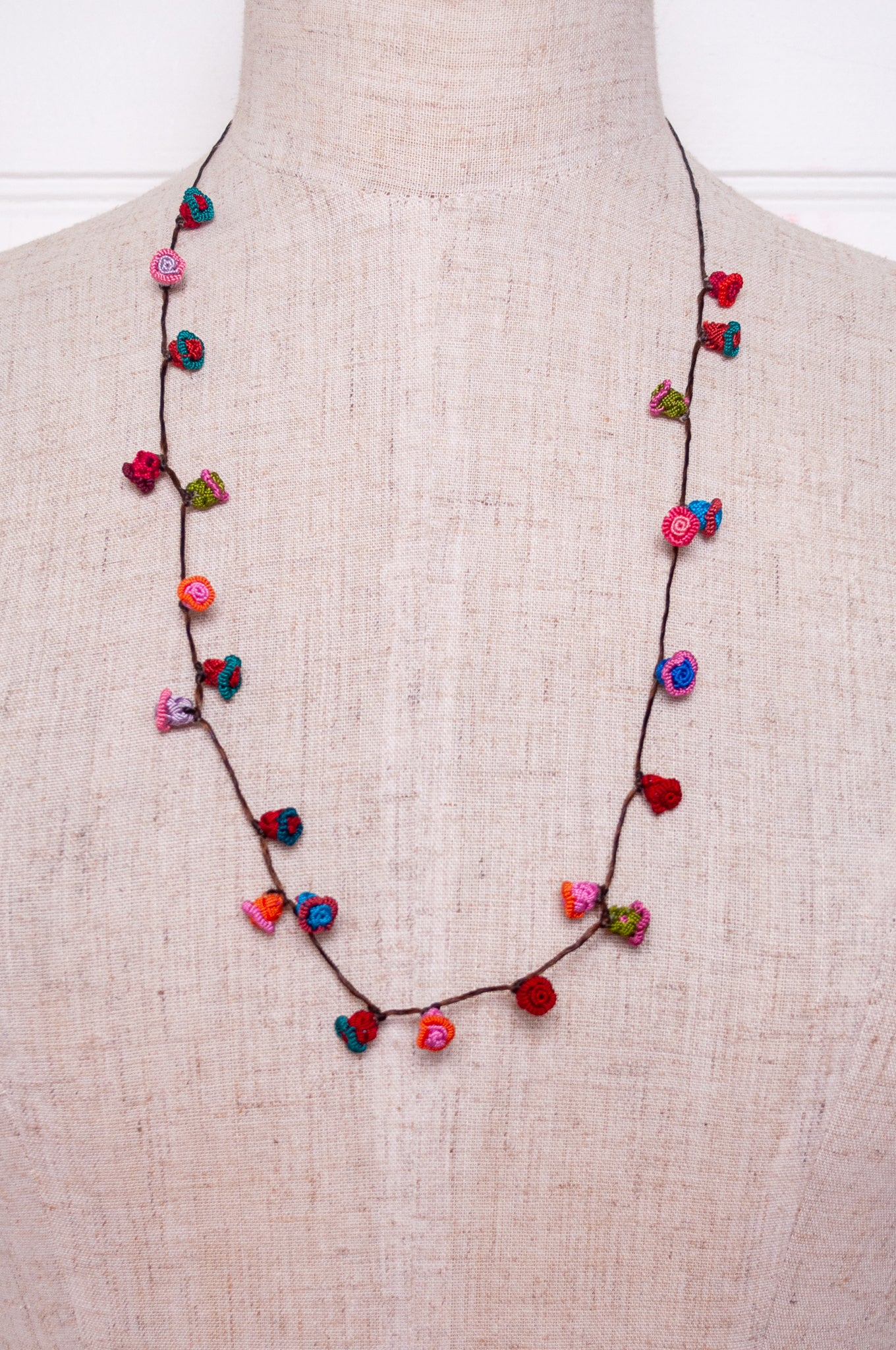 Handmade Moroccan button necklace in turquoise, pink and red.