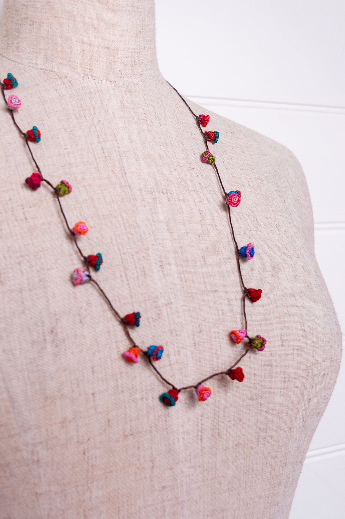 Handmade Moroccan button necklace in turquoise, pink and red.