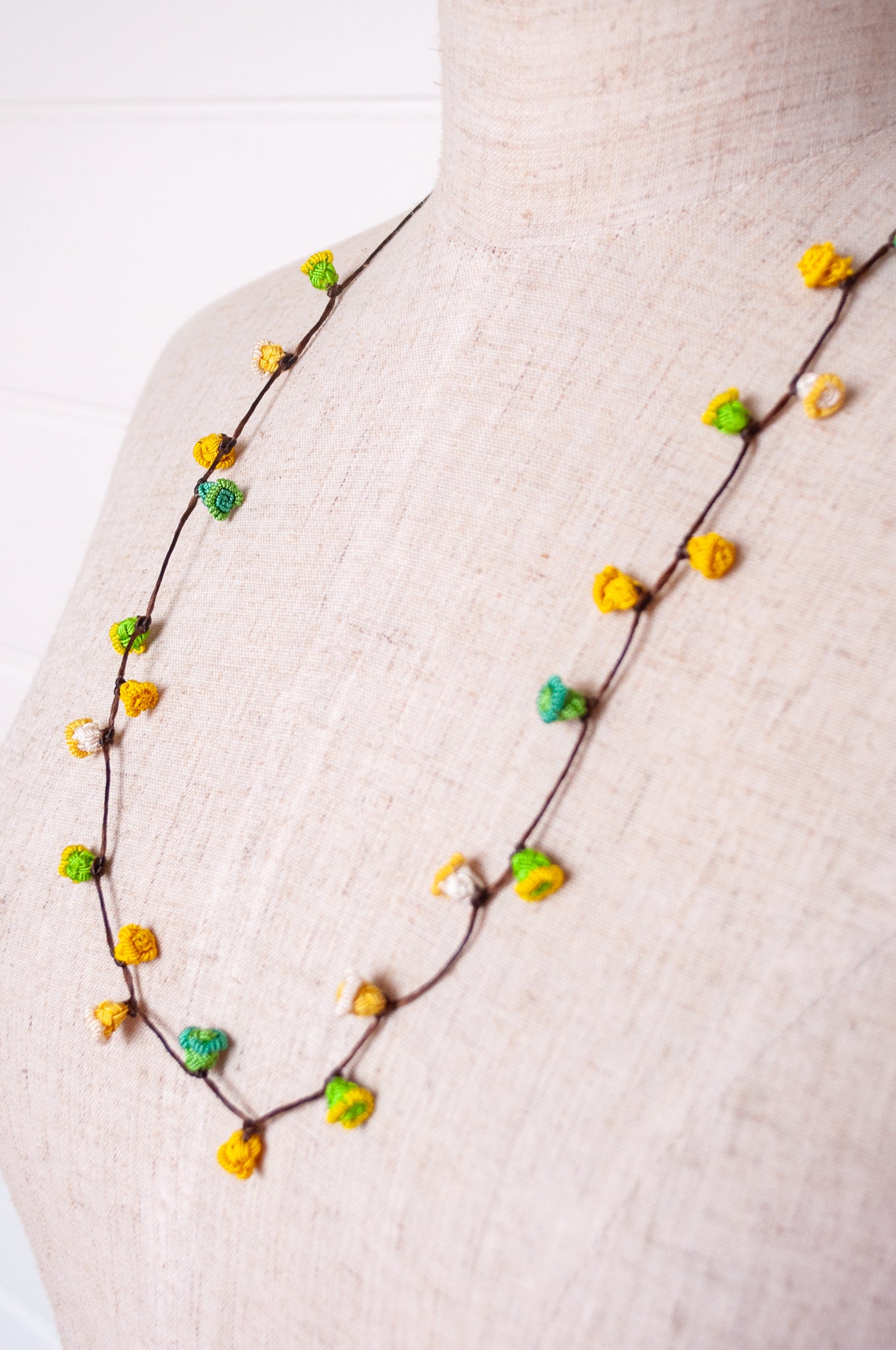 Handmade Moroccan button necklace in lemon yellow and lime green.