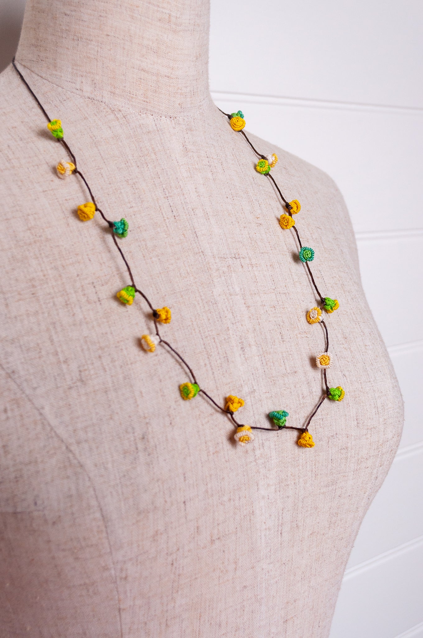 Handmade Moroccan button necklace in lemon yellow and lime green.