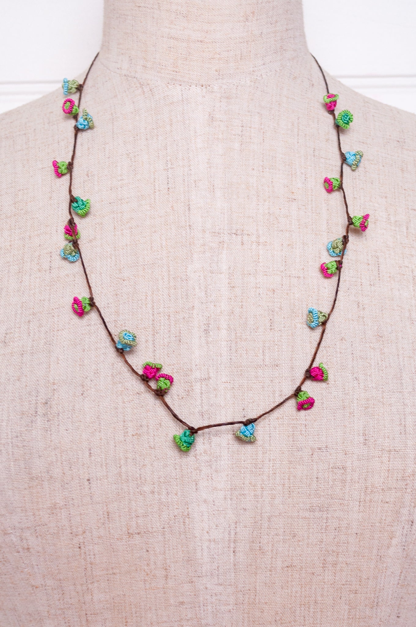 Handmade Moroccan button necklace in blue, pink and soft green.