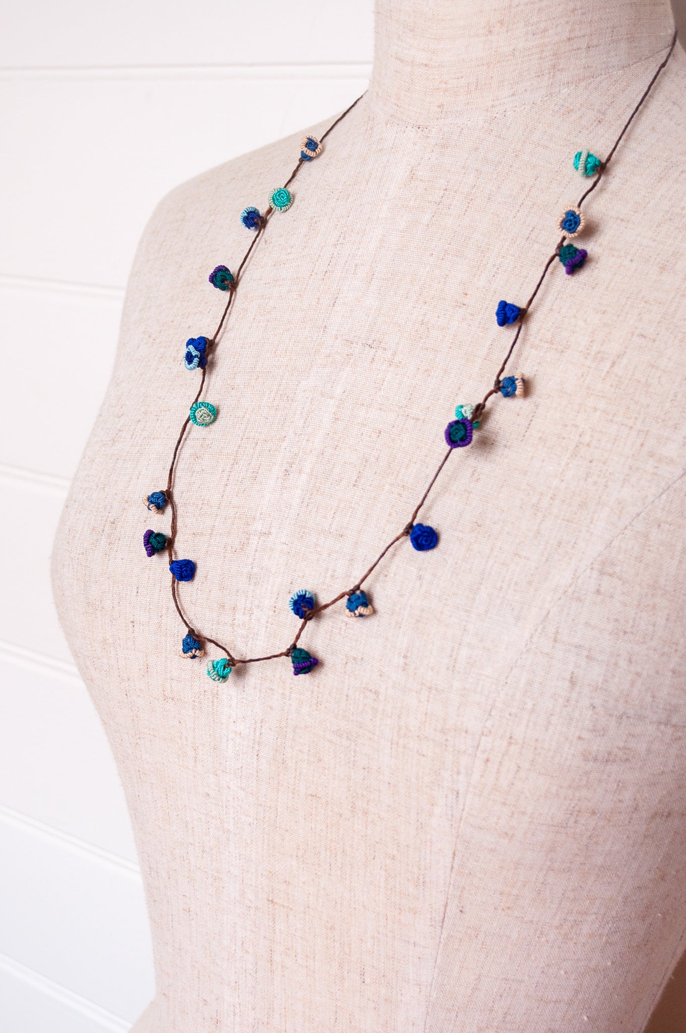 Handmade Moroccan button necklace in ocean blues and greens.