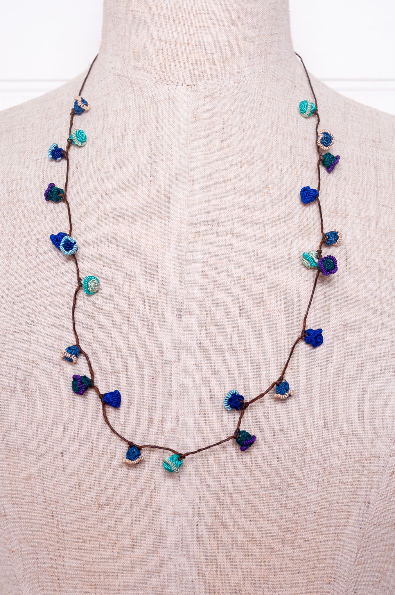 Handmade Moroccan button necklace in ocean blues and greens.