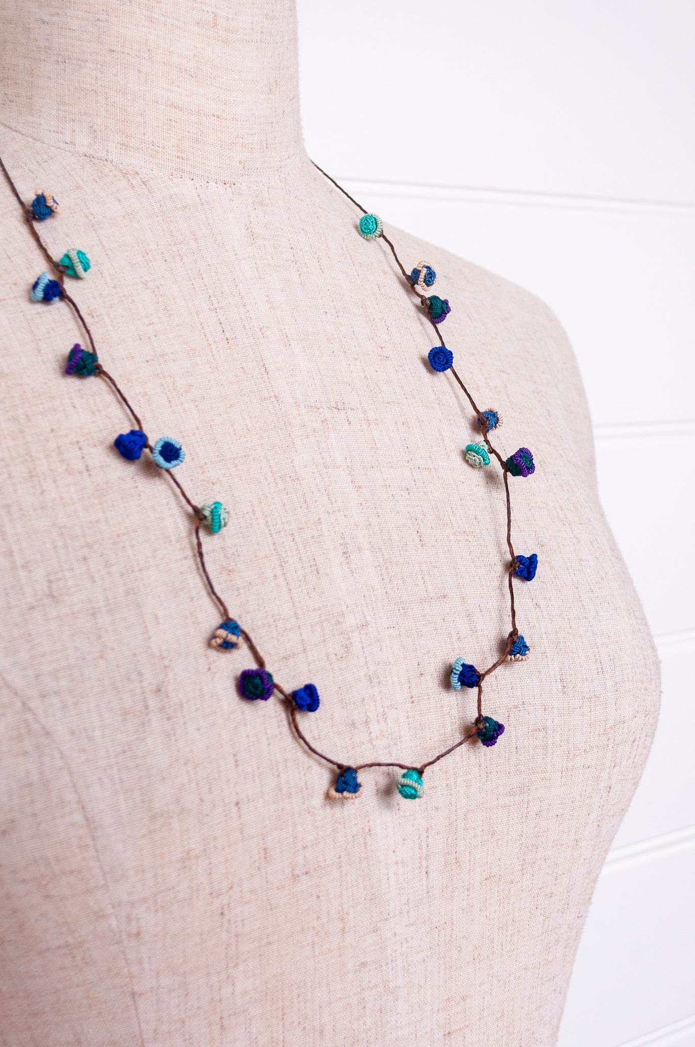 Handmade Moroccan button necklace in ocean blues and greens.