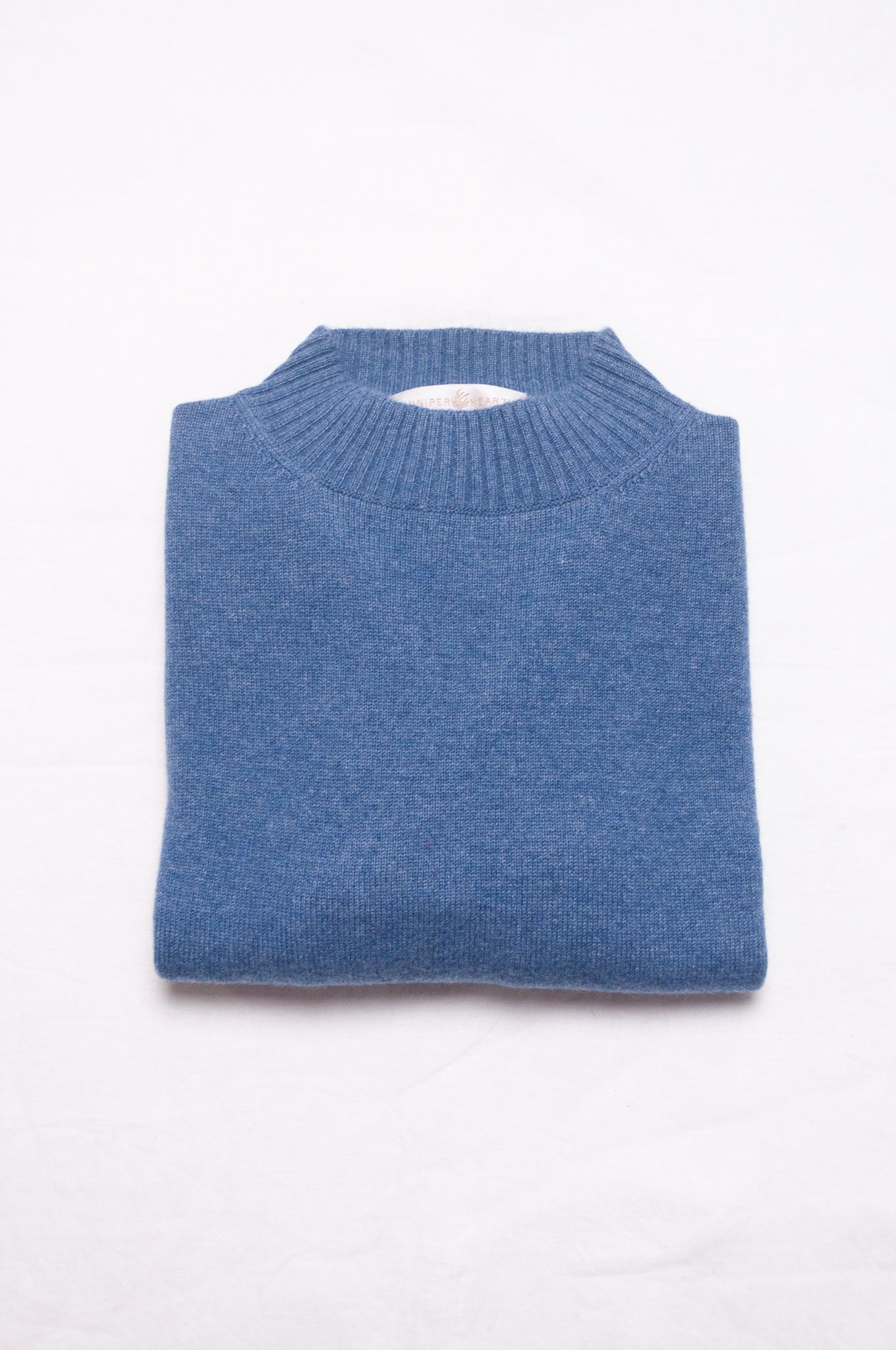 Juniper Hearth high neck turtleneck cashmere sweater in denim blue.