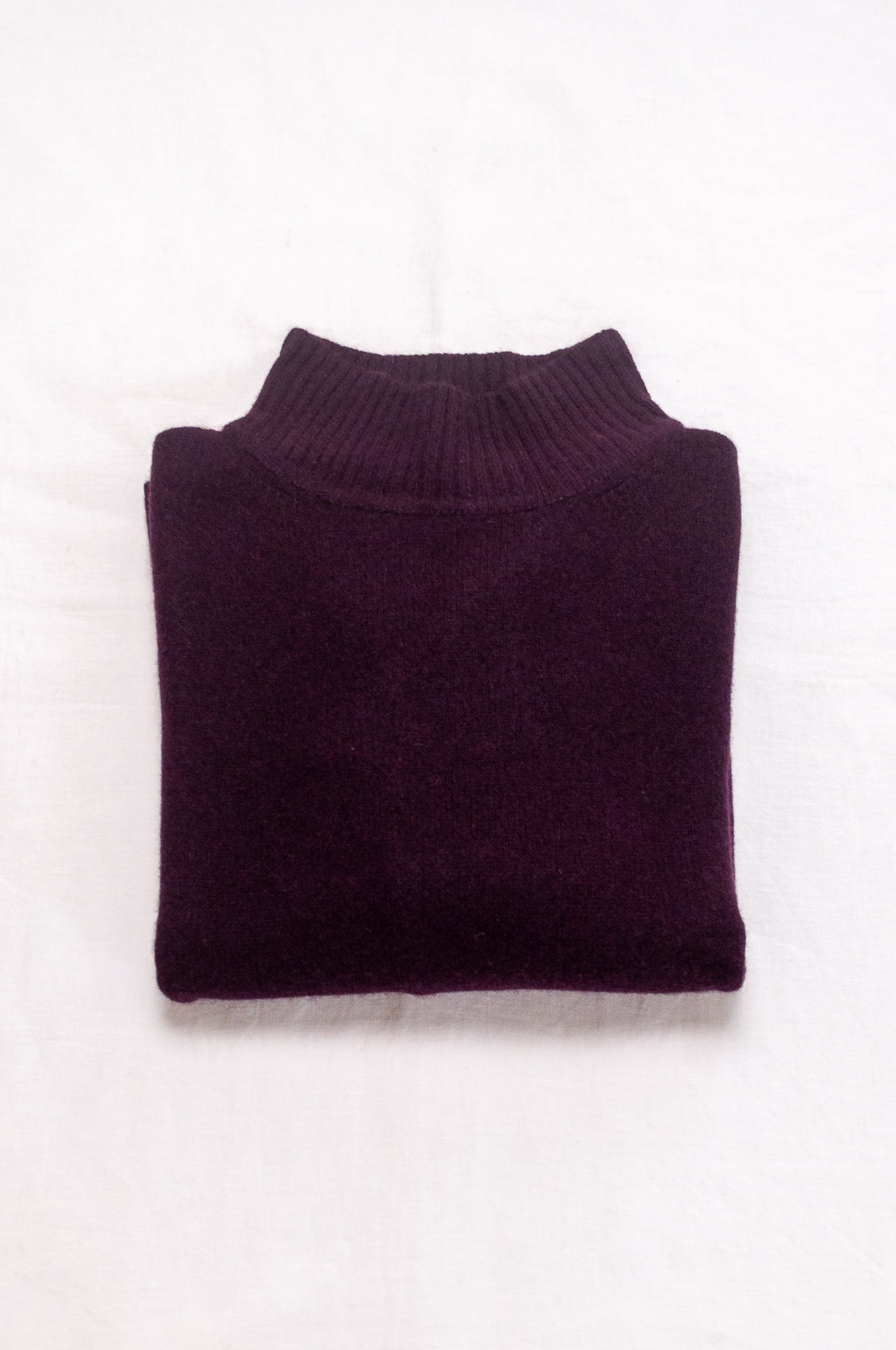 Baby yak wool Maxim one size turtle neck sweater with rib sleeves in aubergine.