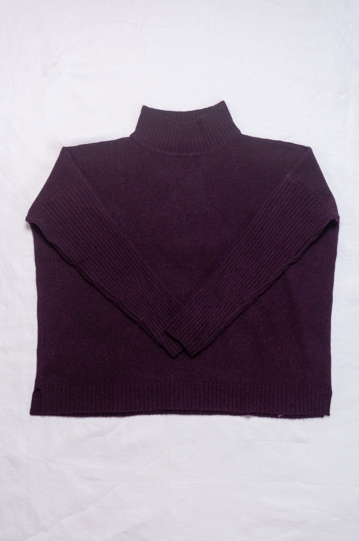 Baby yak wool Maxim one size turtle neck sweater with rib sleeves in aubergine.