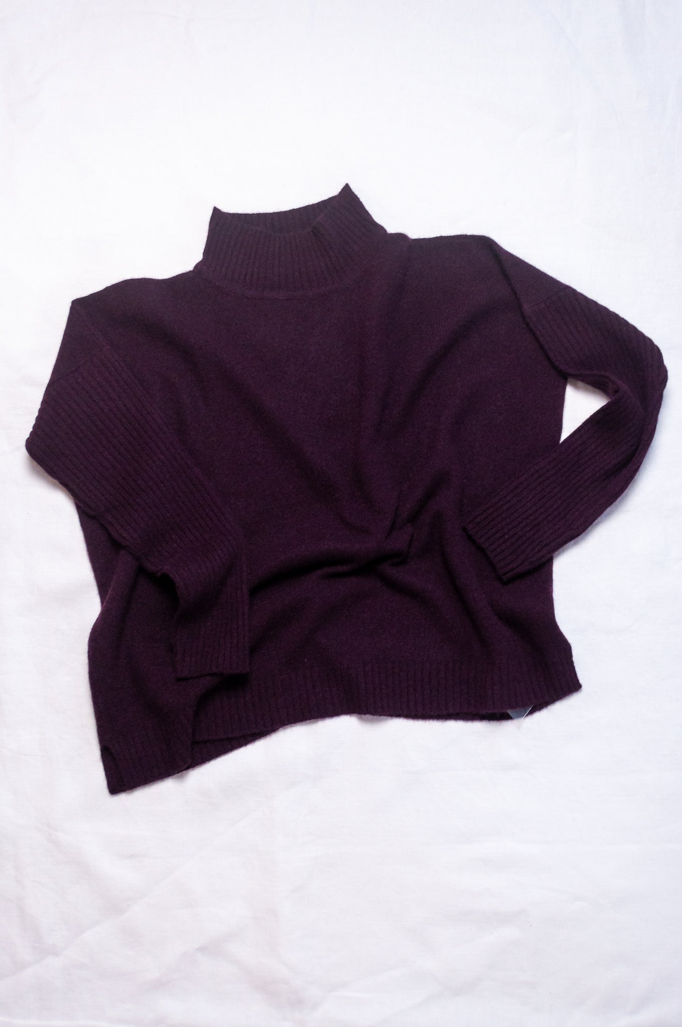 Baby yak wool Maxim one size turtle neck sweater with rib sleeves in aubergine.