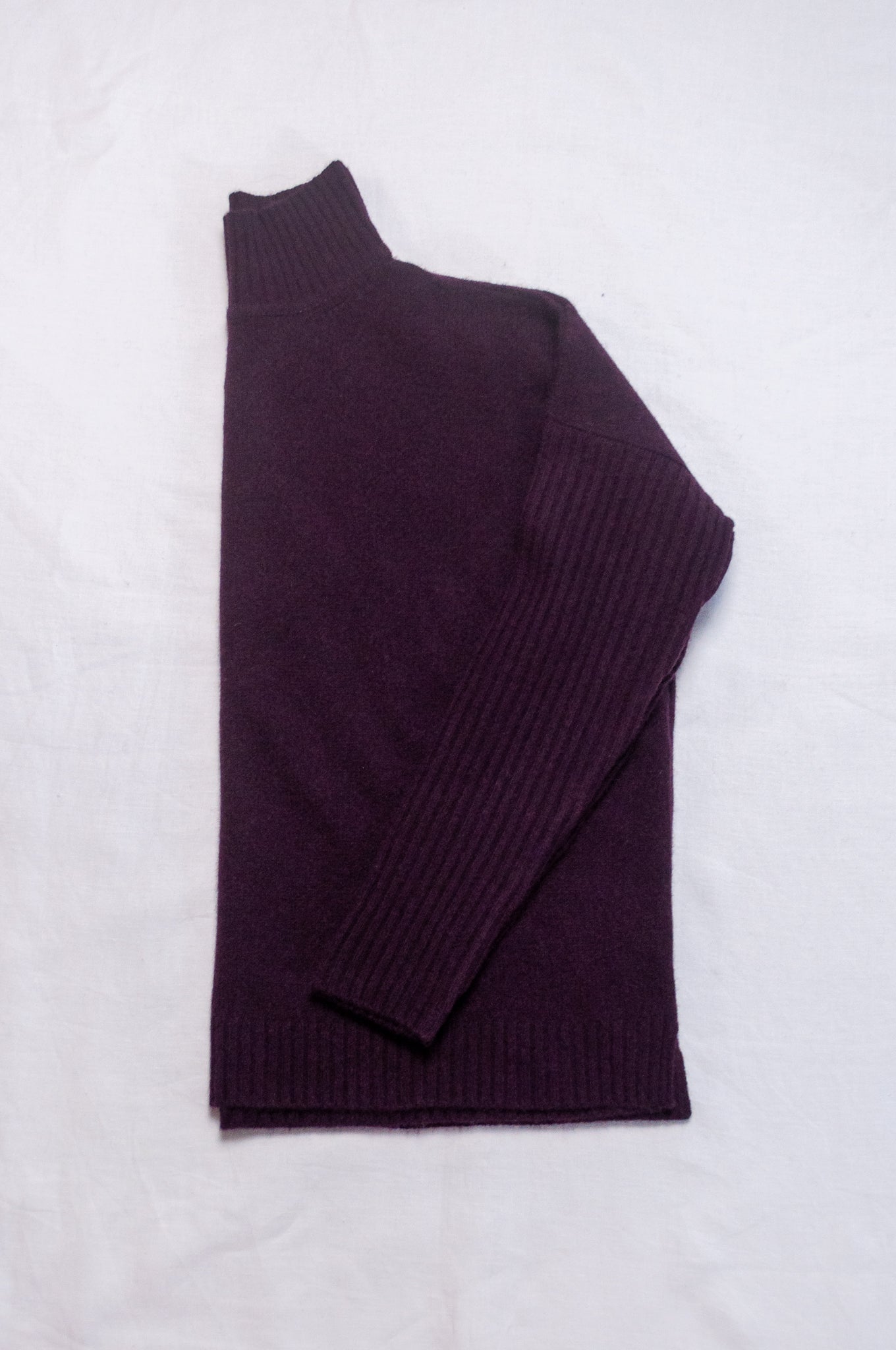 Baby yak wool Maxim one size turtle neck sweater with rib sleeves in aubergine.