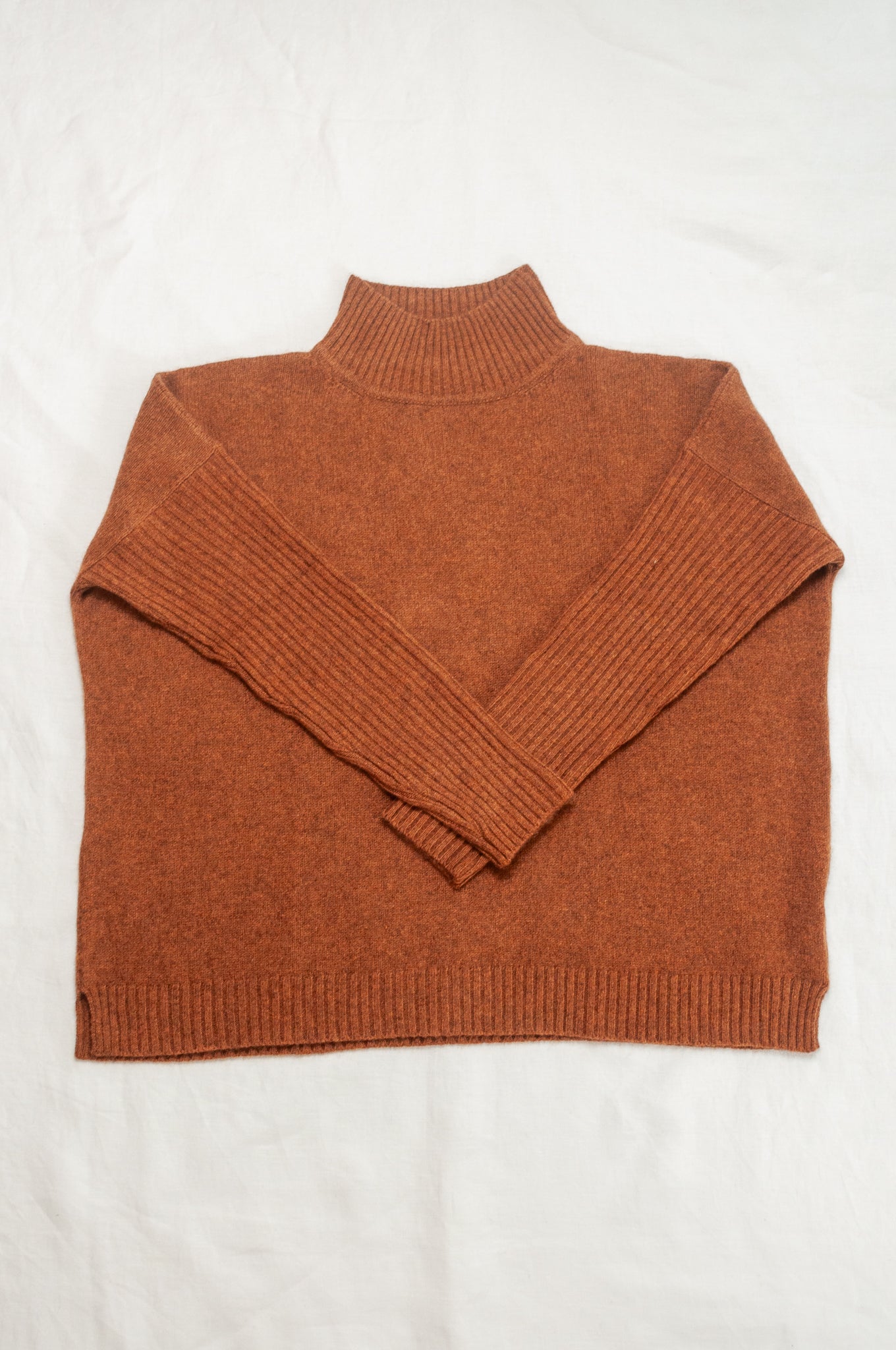 Baby yak wool Maxim one size turtle neck sweater with rib sleeves in rust brown.