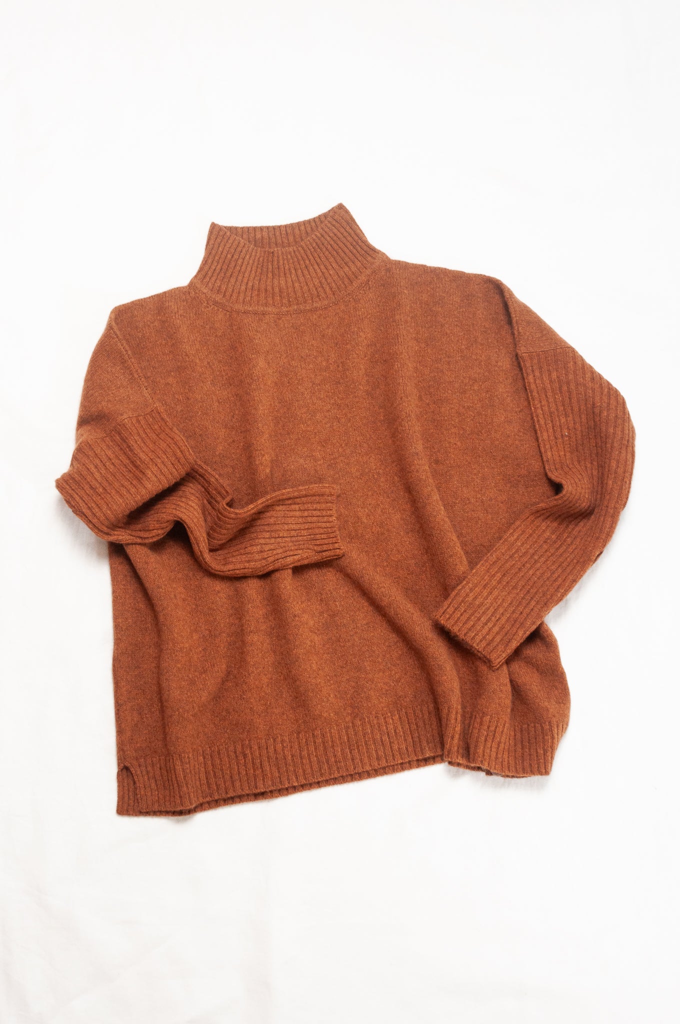 Baby yak wool Maxim one size turtle neck sweater with rib sleeves in rust brown.